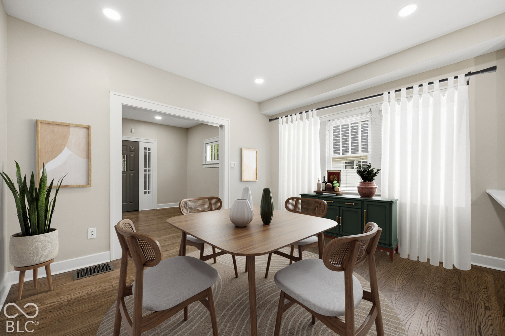Neutral-toned walls, wood-finish flooring, recessed lighting, and multi-pane window with dark metal curtain rod