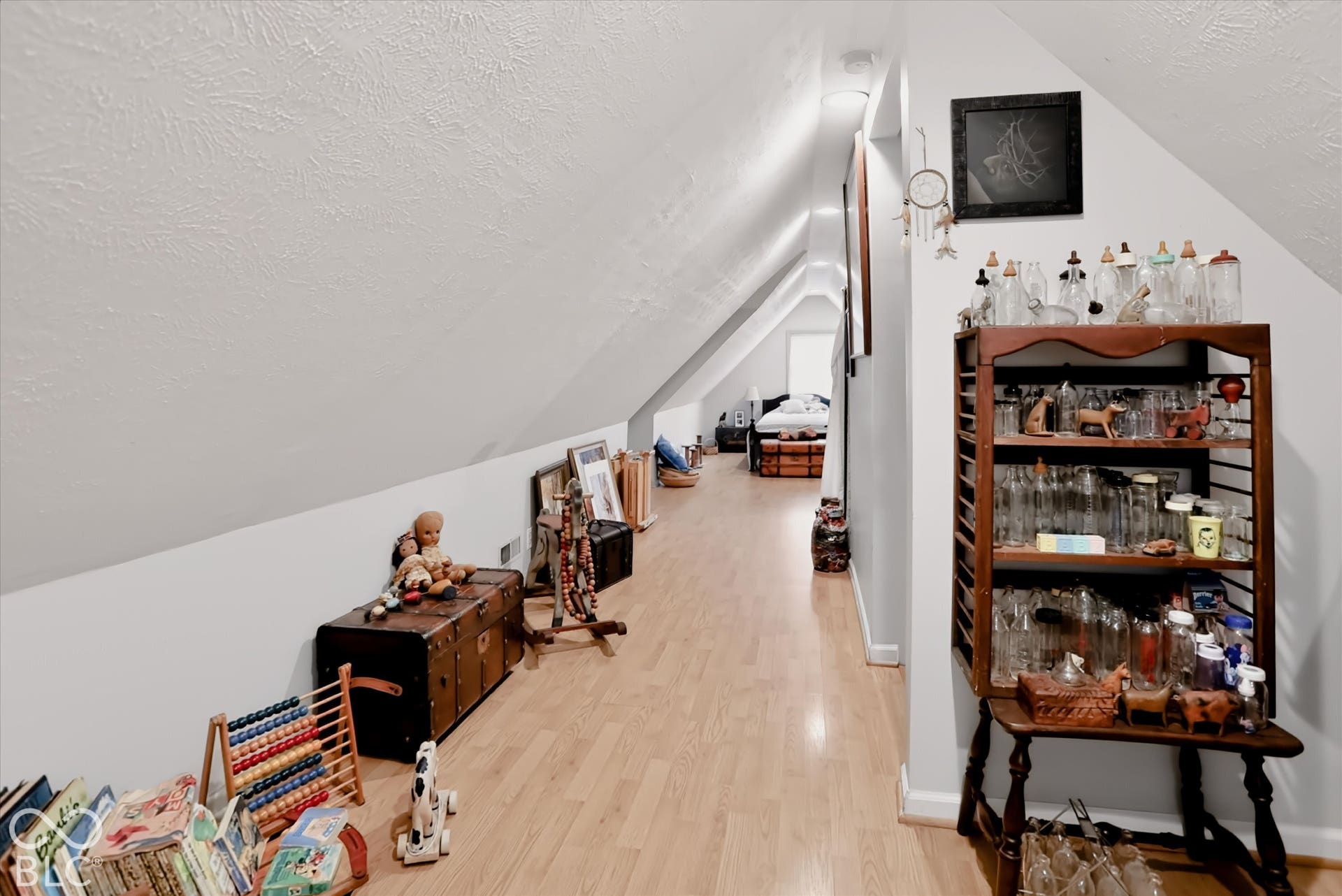 304 W 4th Street, Greenfield, IN 46140 Finished attic space featuring vaulted ceilings, neutral wall paint, and wood-finish flooring