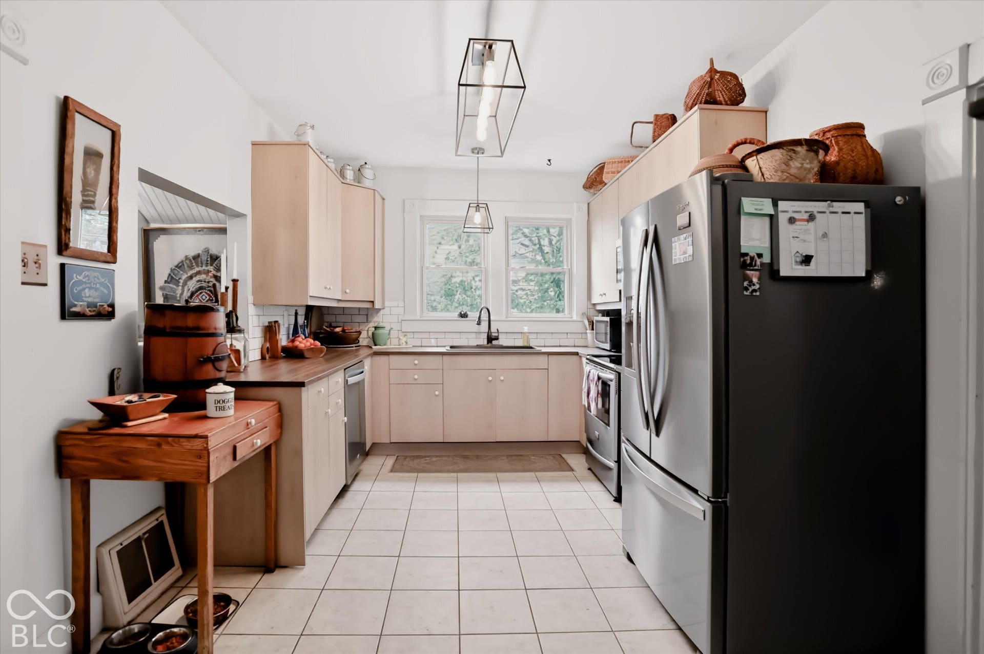 304 W 4th Street, Greenfield, IN 46140 Kitchen featuring light-finish cabinetry, dark solid-surface countertops, subway tile backsplash, stainless steel appliances, and rectangular tile flooring