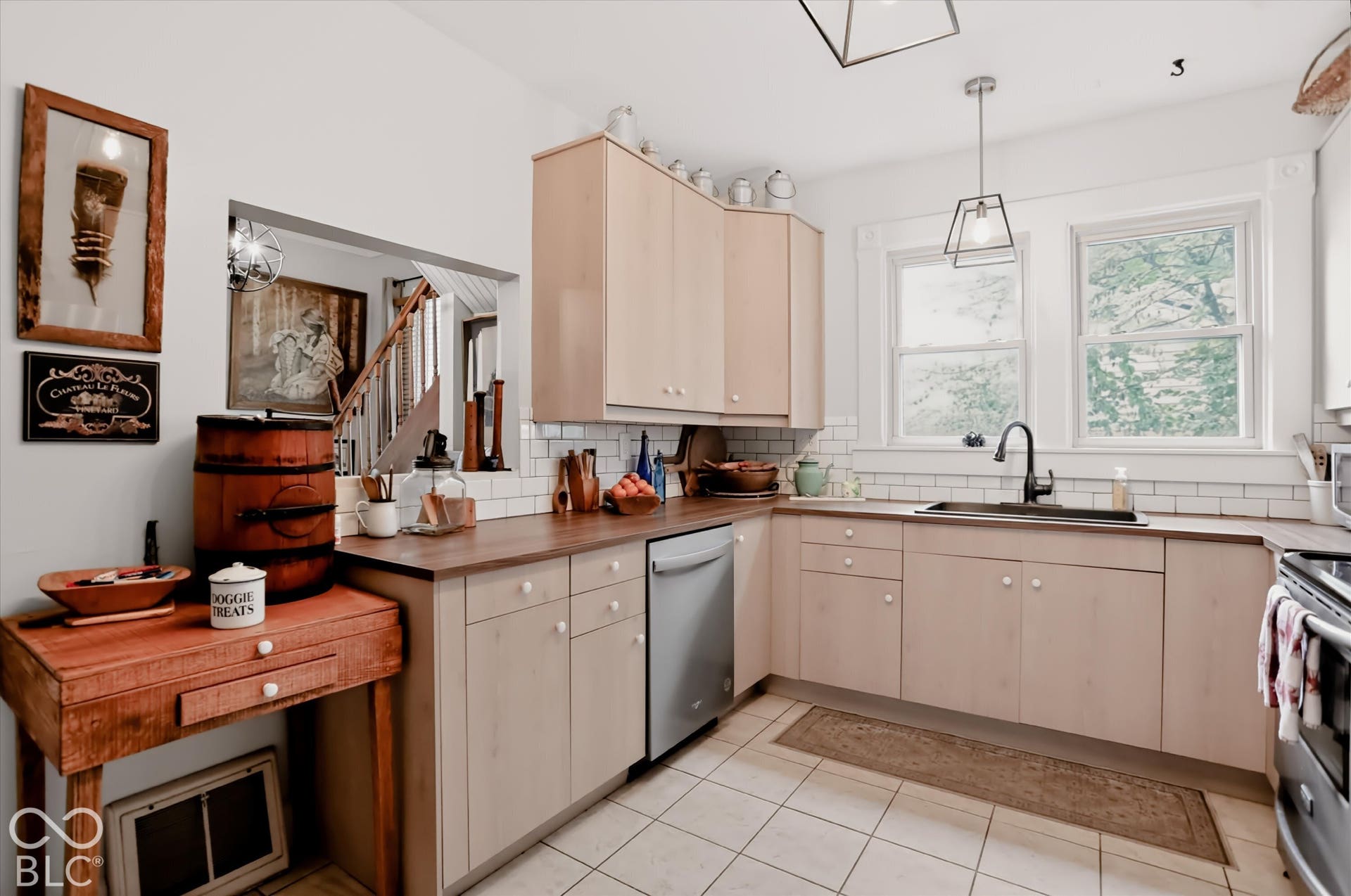 304 W 4th Street, Greenfield, IN 46140 Kitchen featuring light-finish cabinetry, dark wood-tone countertops, white subway tile backsplash, ceramic tile flooring, and matte black hardware