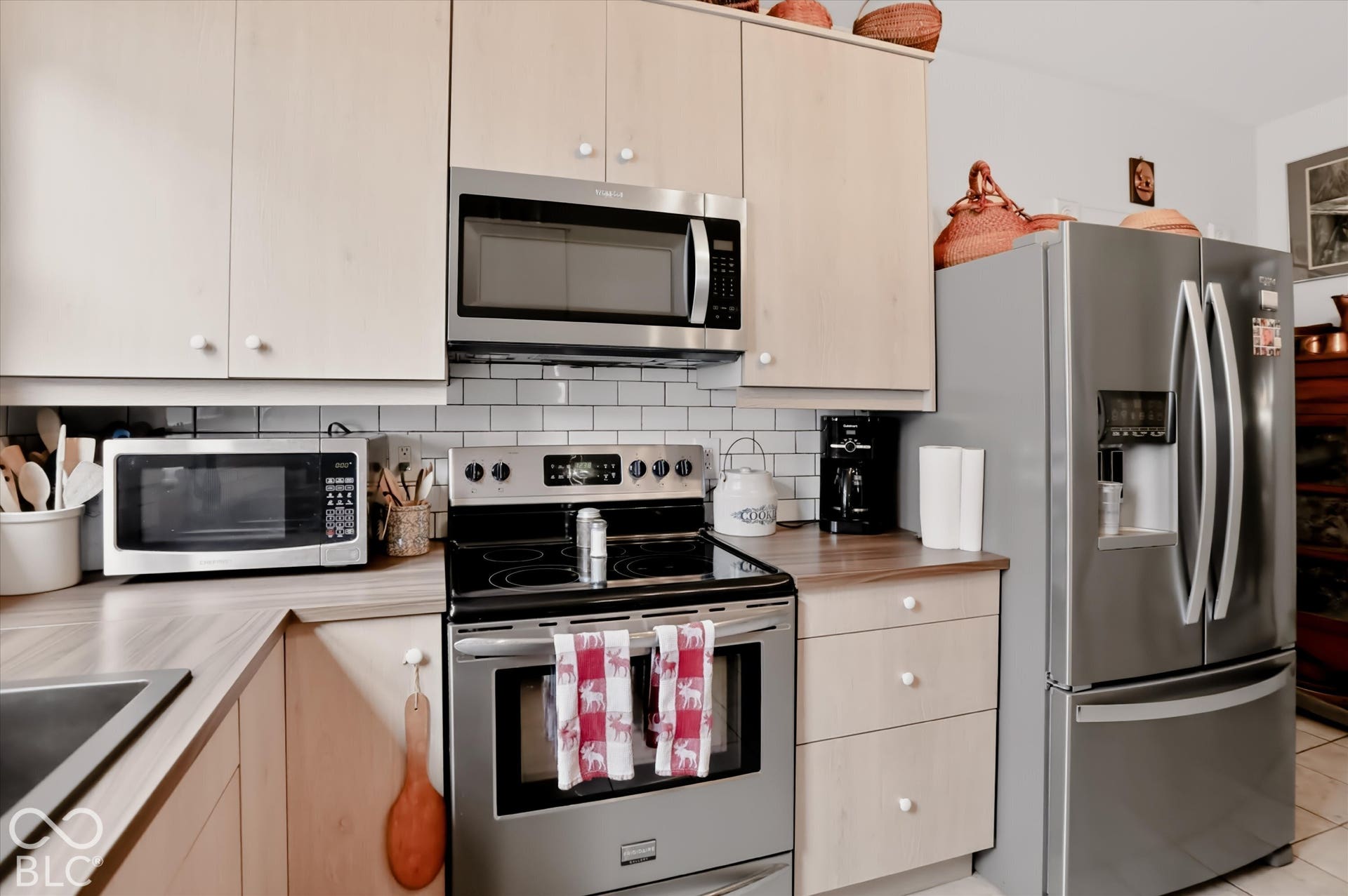 304 W 4th Street, Greenfield, IN 46140 Kitchen featuring light-finish cabinetry, stainless steel appliances, a glass-top electric range, and a subway tile backsplash