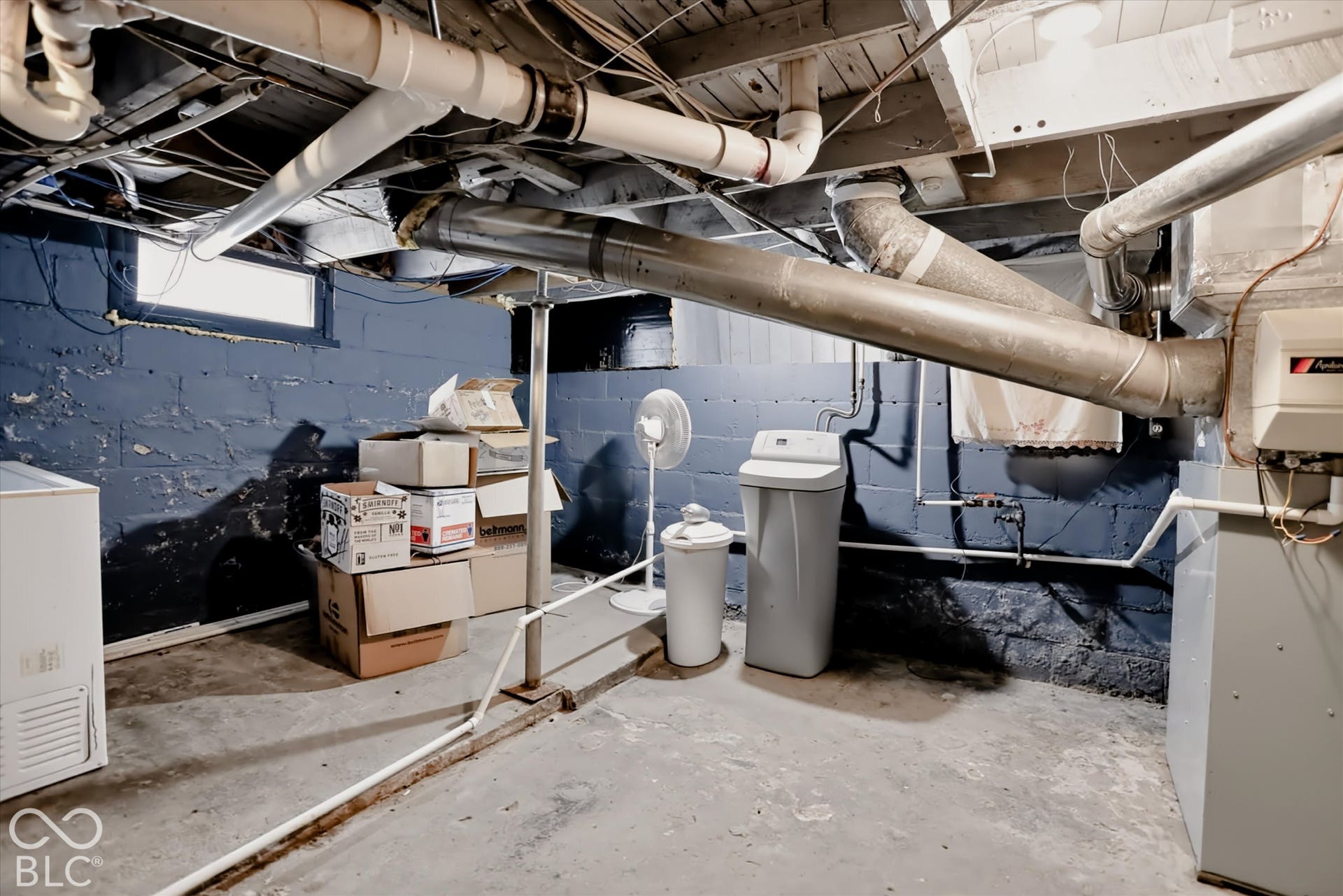 304 W 4th Street, Greenfield, IN 46140 Unfinished basement featuring concrete foundation walls, exposed ceiling joists, concrete flooring, and an installed water softener system