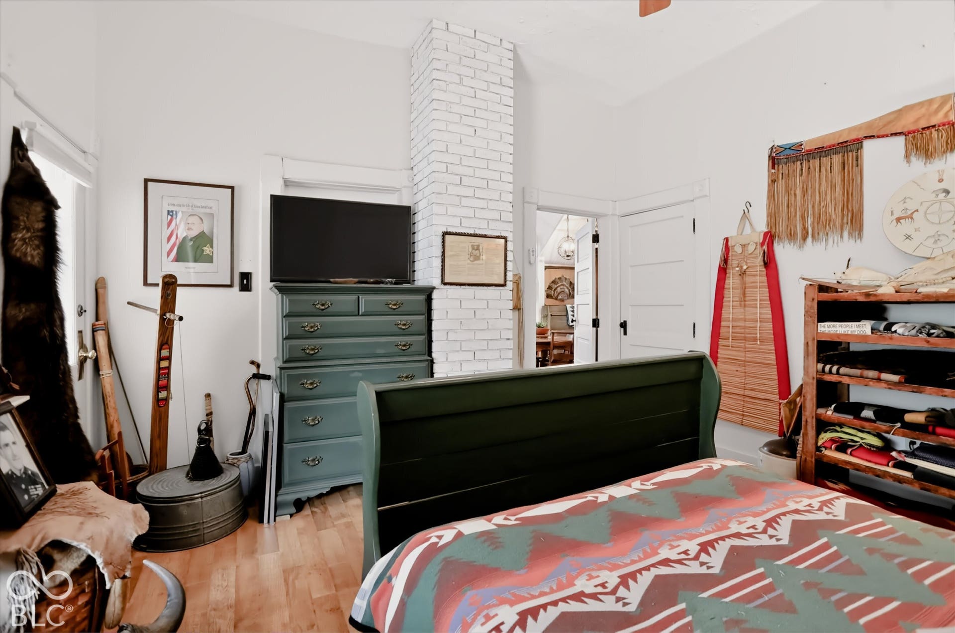 304 W 4th Street, Greenfield, IN 46140 Exposed white-painted brick chimney, wood-finish flooring, and solid-core interior doors with traditional millwork trim
