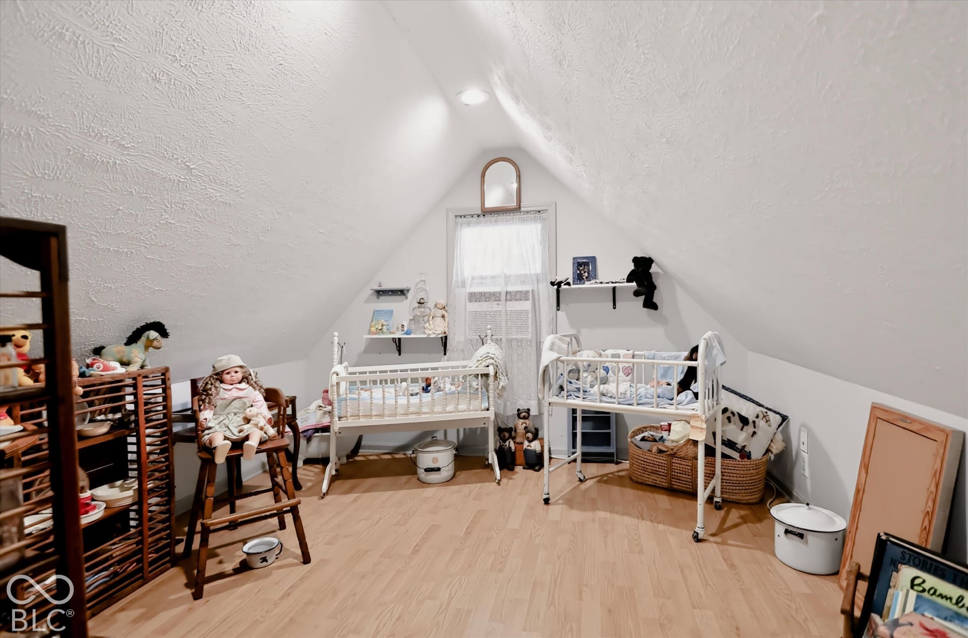 304 W 4th Street, Greenfield, IN 46140 Attic room featuring a peaked ceiling, wood-finish flooring, recessed lighting, and a window with a centered arch-top mirror