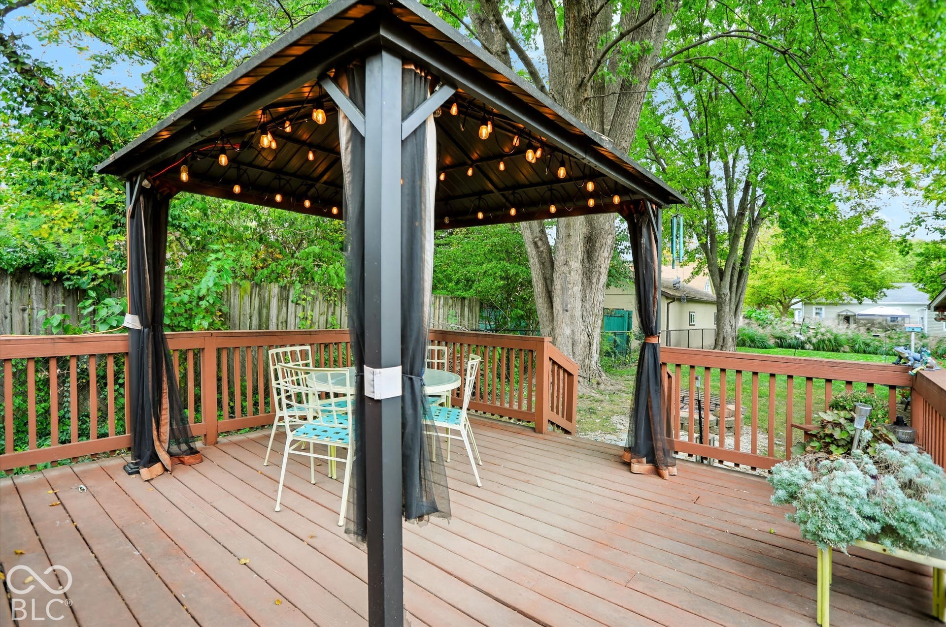 304 W 4th Street, Greenfield, IN 46140 Elevated wood deck featuring a metal-framed gazebo with a permanent canopy and integrated string lighting, enclosed by a wood railing