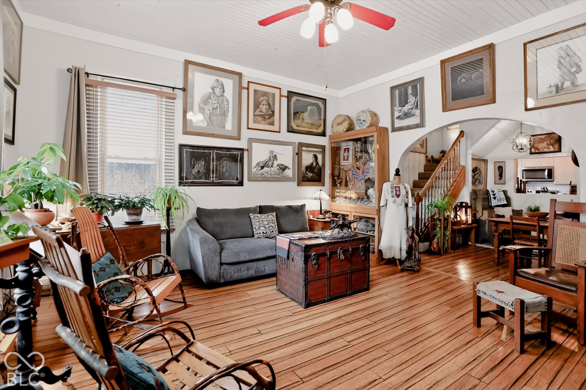 304 W 4th Street, Greenfield, IN 46140 Hardwood flooring, wood-paneled ceiling, built-in display cabinetry, arched doorway, and staircase with wooden banister