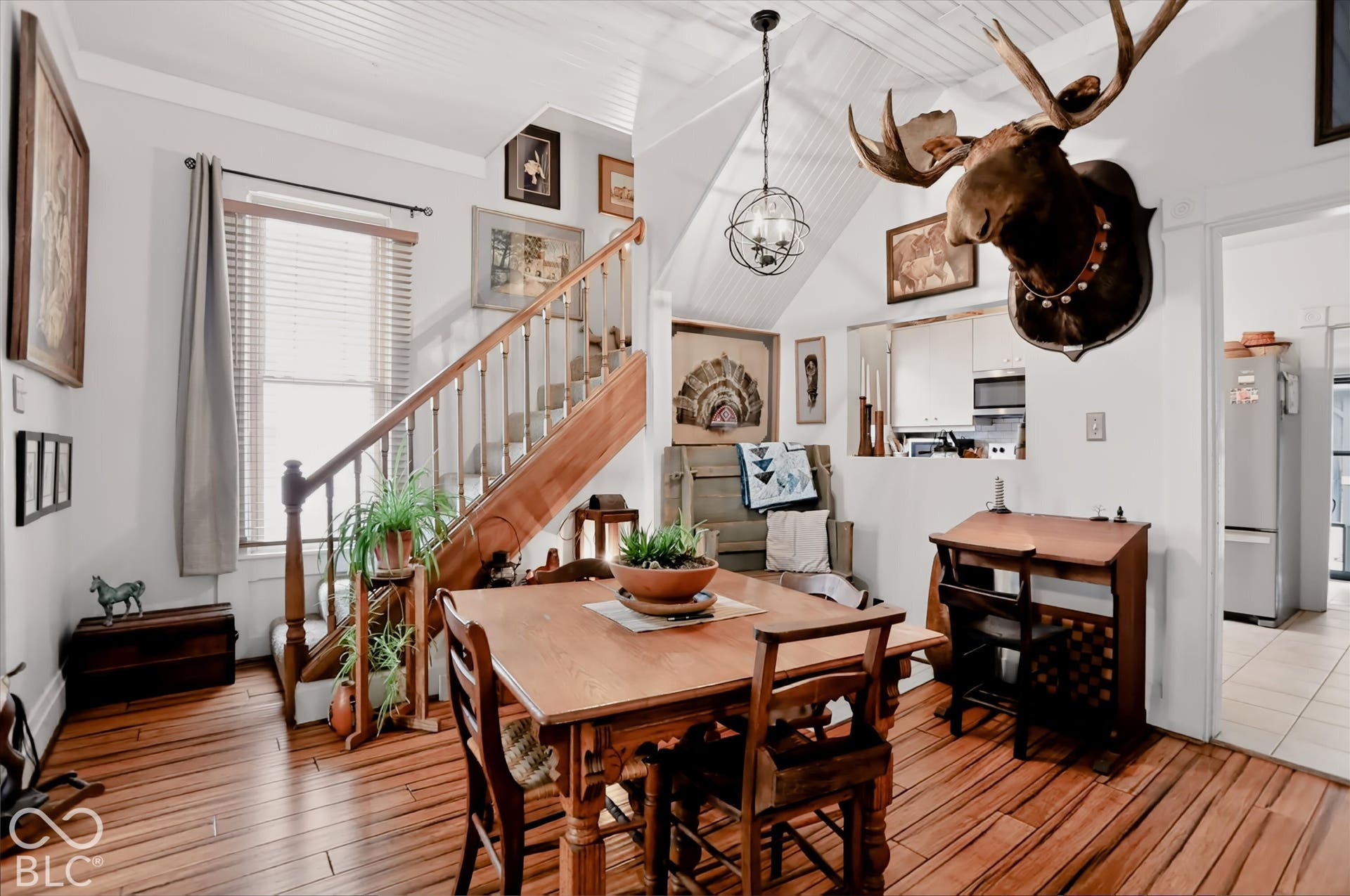 304 W 4th Street, Greenfield, IN 46140 Interior space featuring wood-finish flooring, a wood-railed staircase, beadboard ceiling, and a spherical metal pendant light fixture