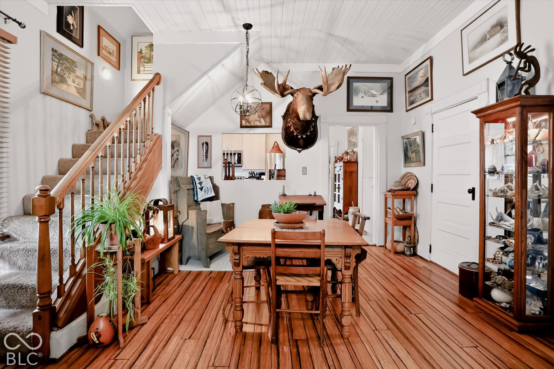 304 W 4th Street, Greenfield, IN 46140 Interior space featuring wood-finish flooring, vaulted shiplap ceiling, staircase with wooden balusters, and a spherical metal chandelier