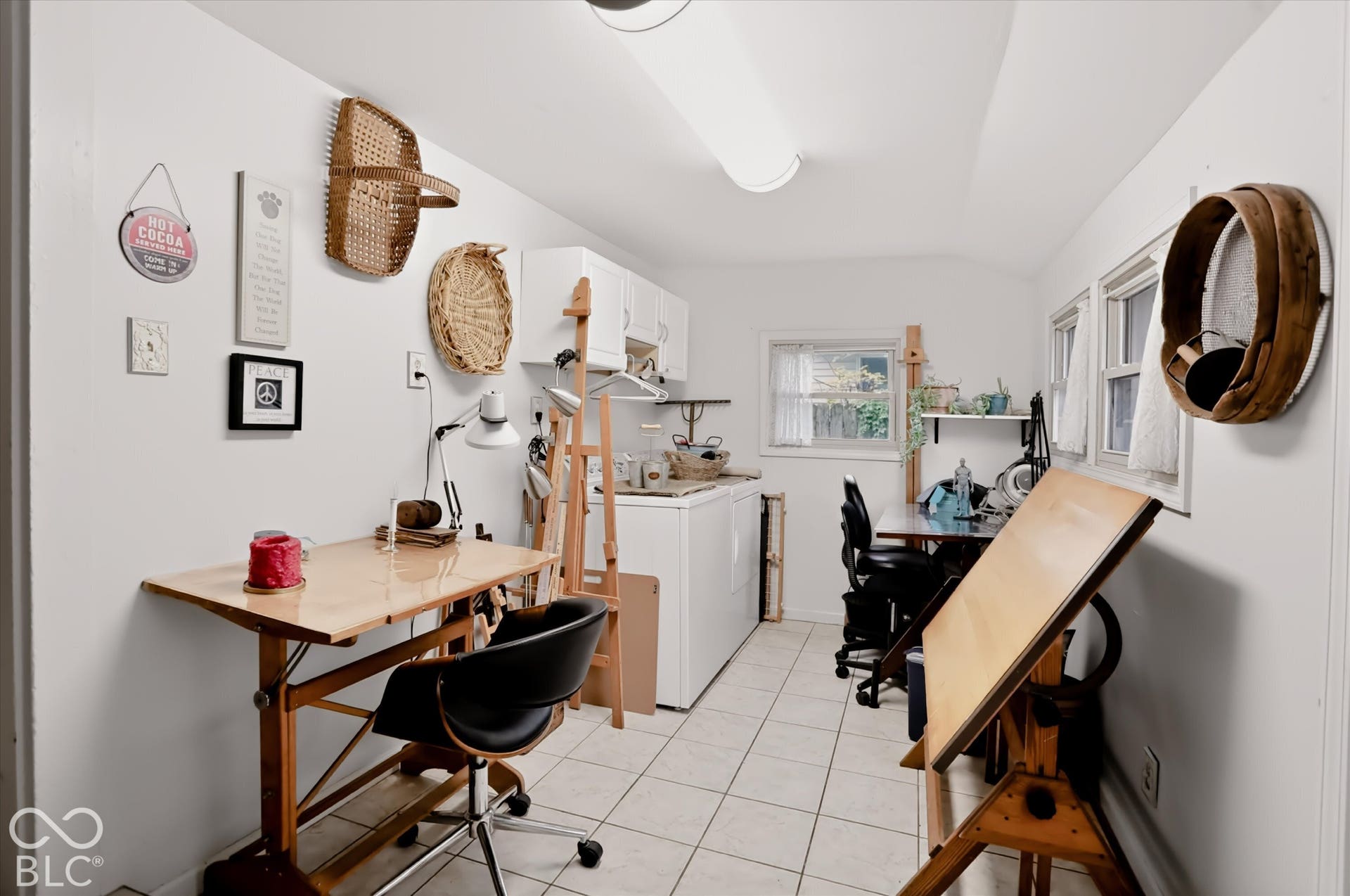 304 W 4th Street, Greenfield, IN 46140 Tile flooring, white wall-mounted cabinetry, integrated laundry appliances, linear fluorescent lighting, and two operable windows