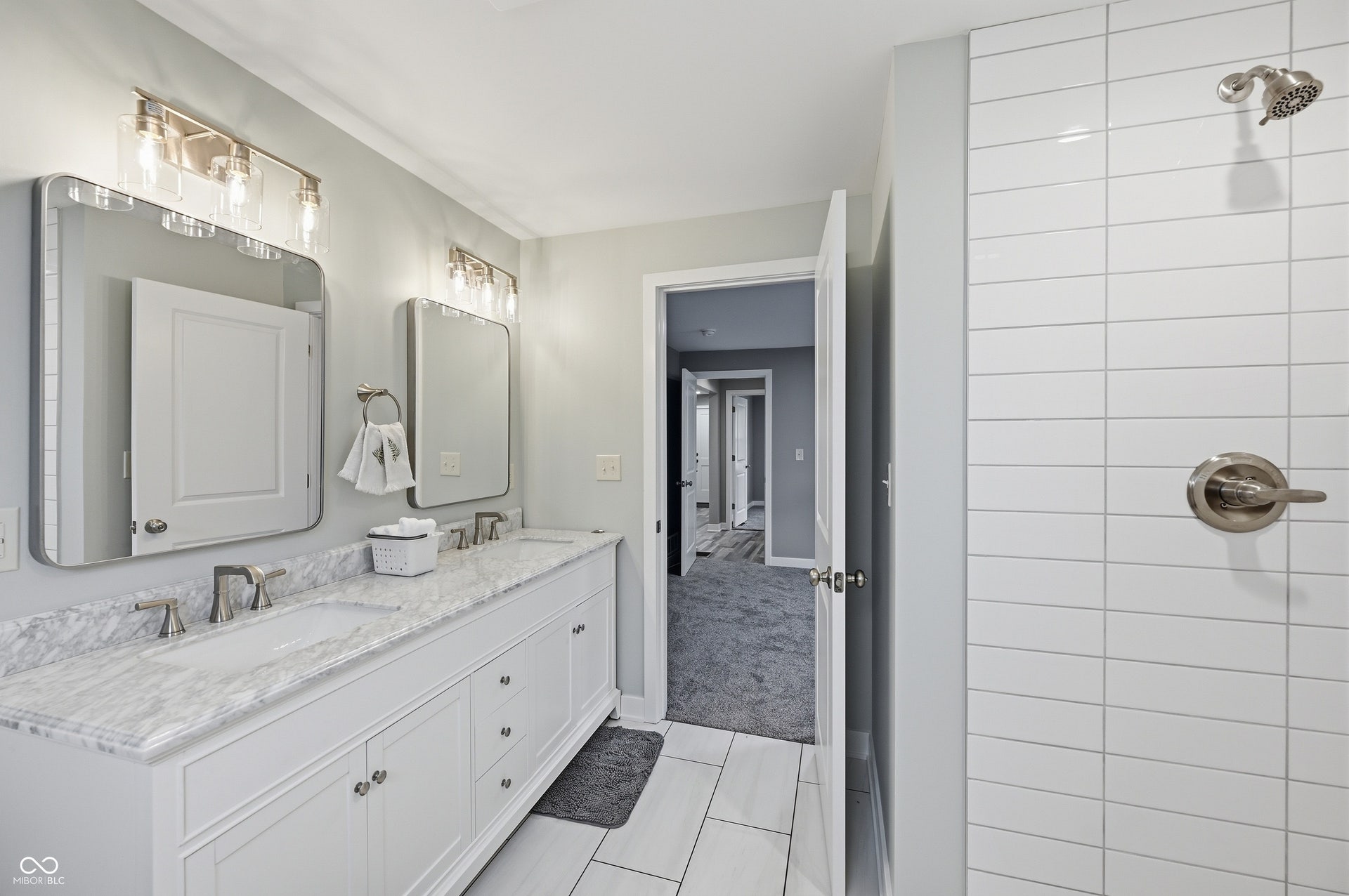 Double vanity with under-mount sinks and stone countertop