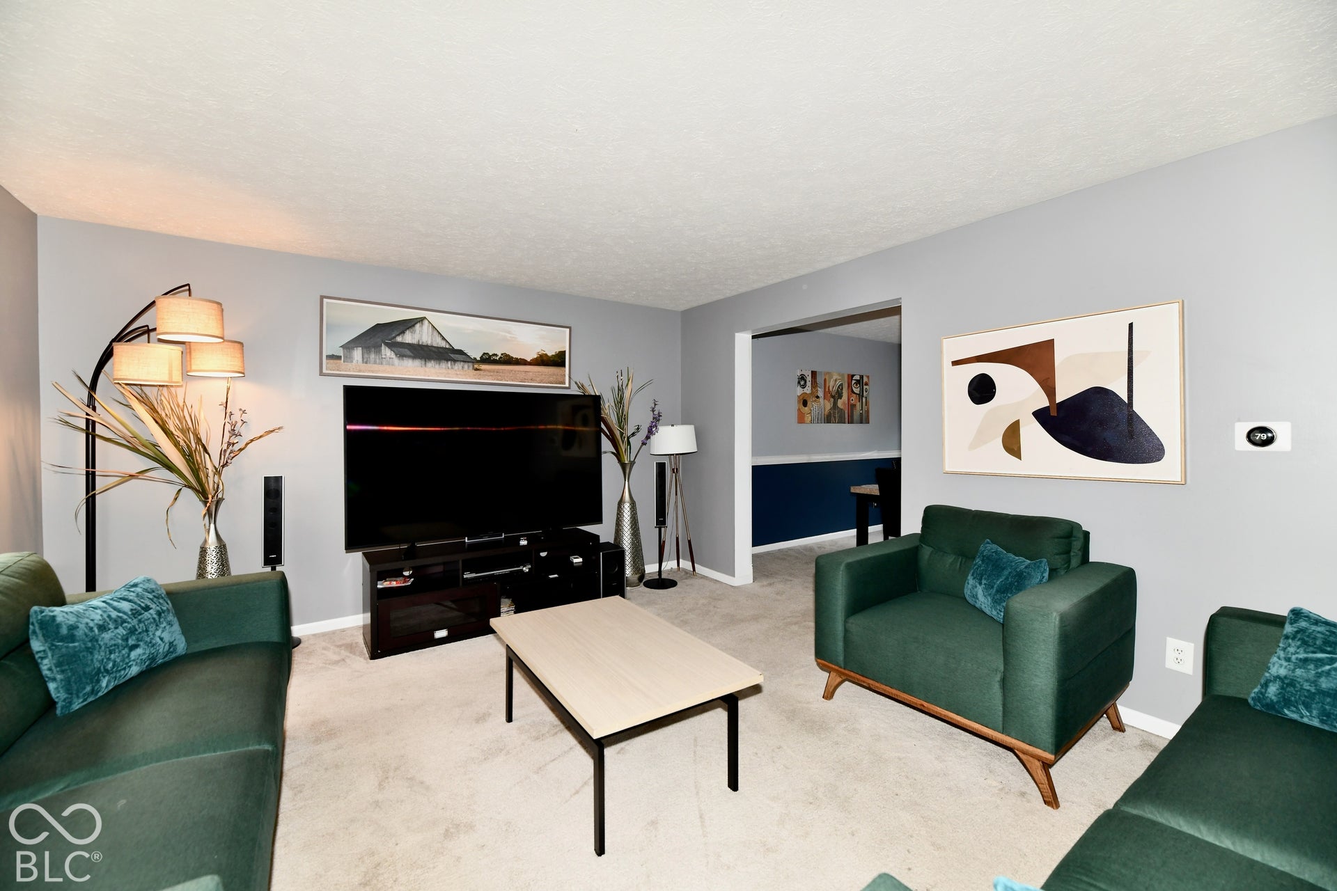 Neutral wall color, wall-to-wall carpeting, and wide entryway