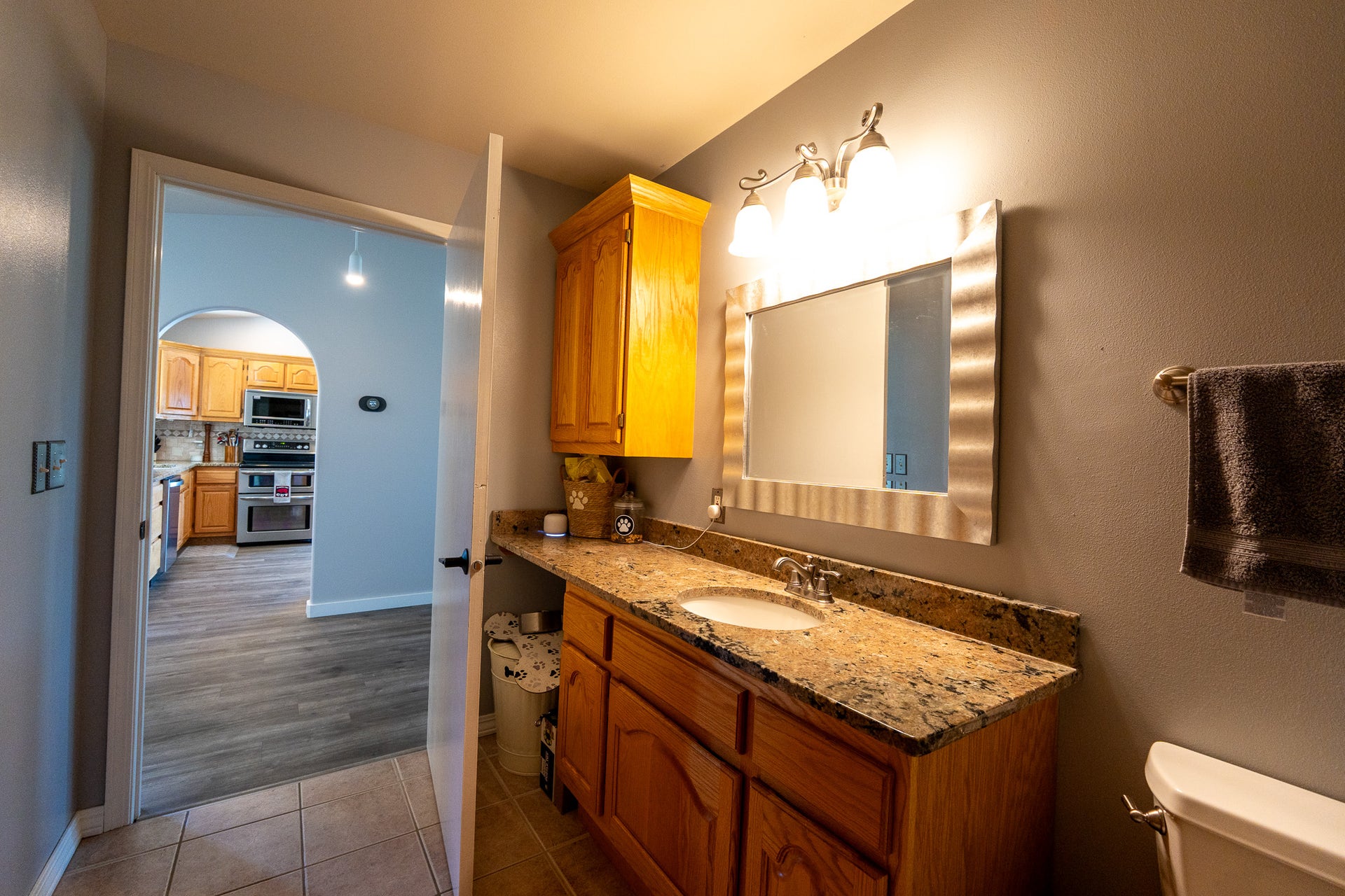 4134 Fox Ridge Drive, Helena, MT 59602 Bathroom with laundry, vanity, toilet, tile patterned flooring, and baseboards