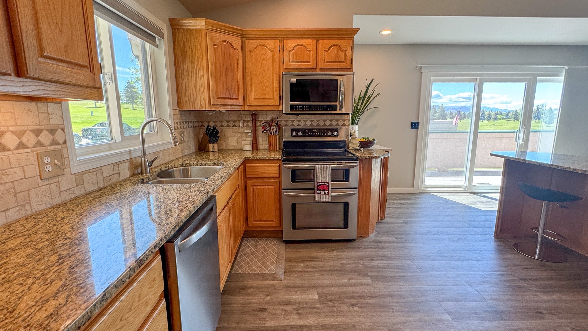 4134 Fox Ridge Drive, Helena, MT 59602 Kitchen featuring appliances with stainless steel finishes, a sink, light stone countertops, light wood finished floors, and recessed lighting