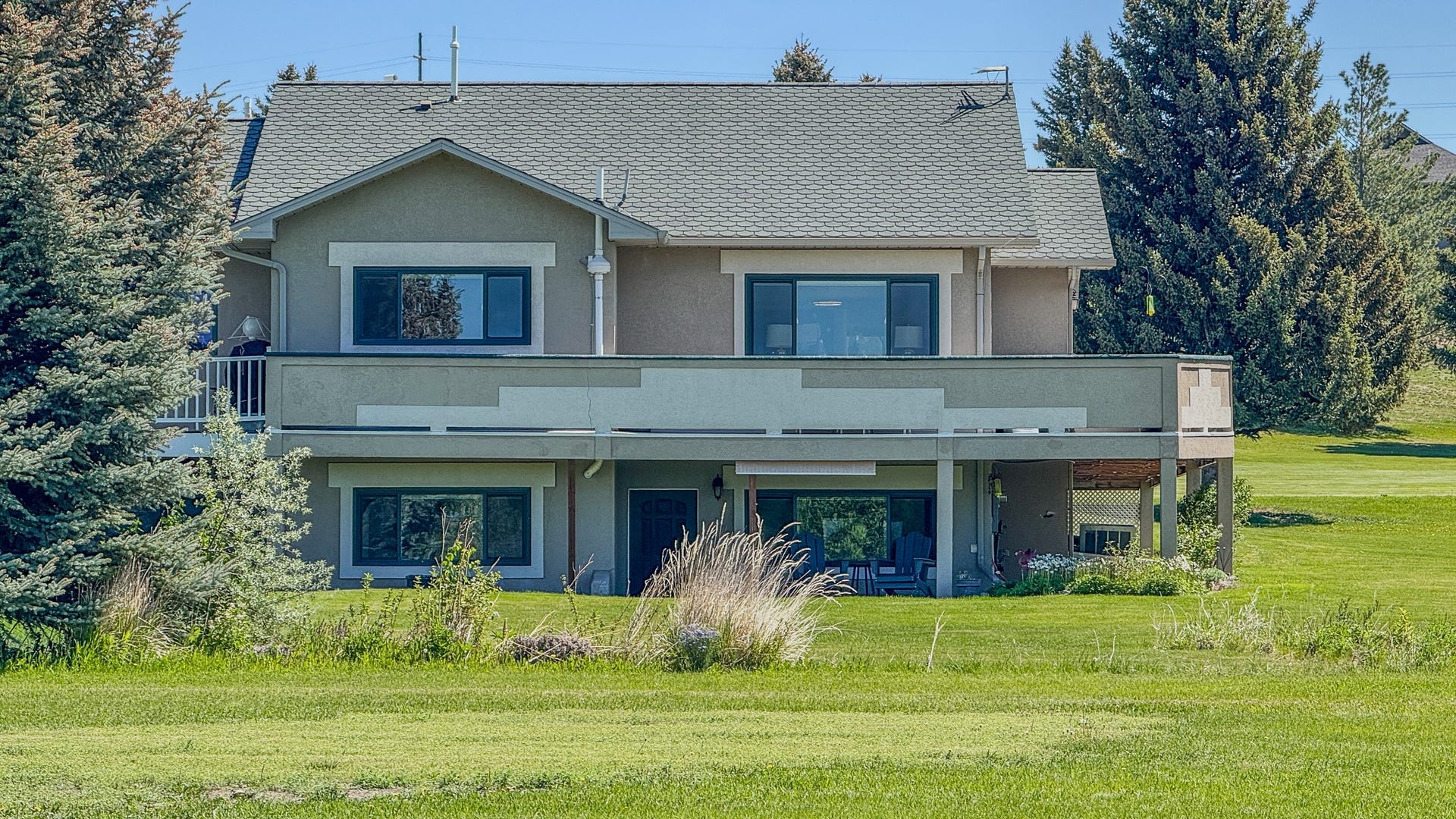 4134 Fox Ridge Drive, Helena, MT 59602 View of front of house with stucco siding and a front lawn