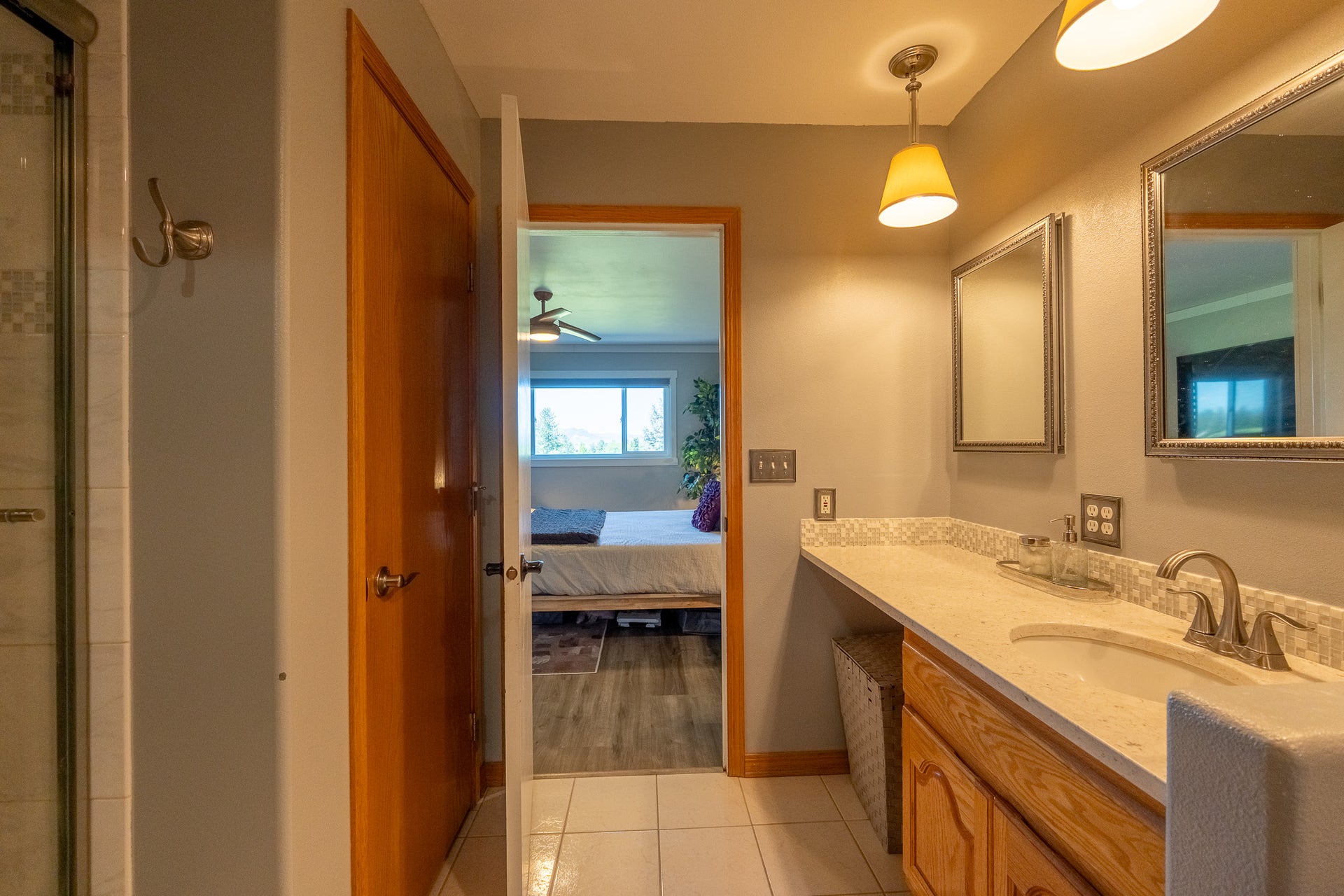 4134 Fox Ridge Drive, Helena, MT 59602 Bathroom with vanity, ensuite bath, a shower with door, tile patterned floors, and baseboards