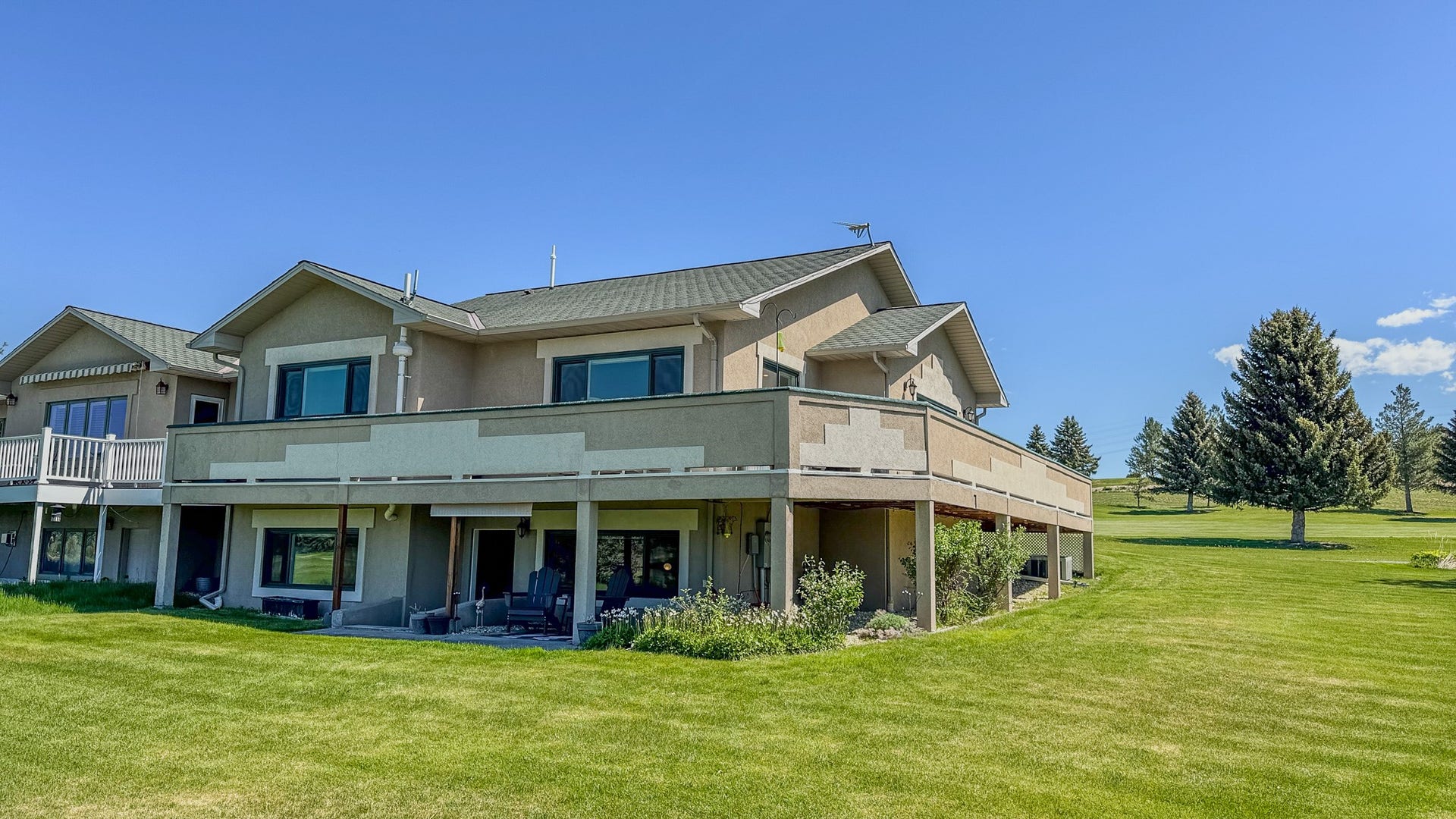 4134 Fox Ridge Drive, Helena, MT 59602 Rear view of property with stucco siding, a yard, and a deck