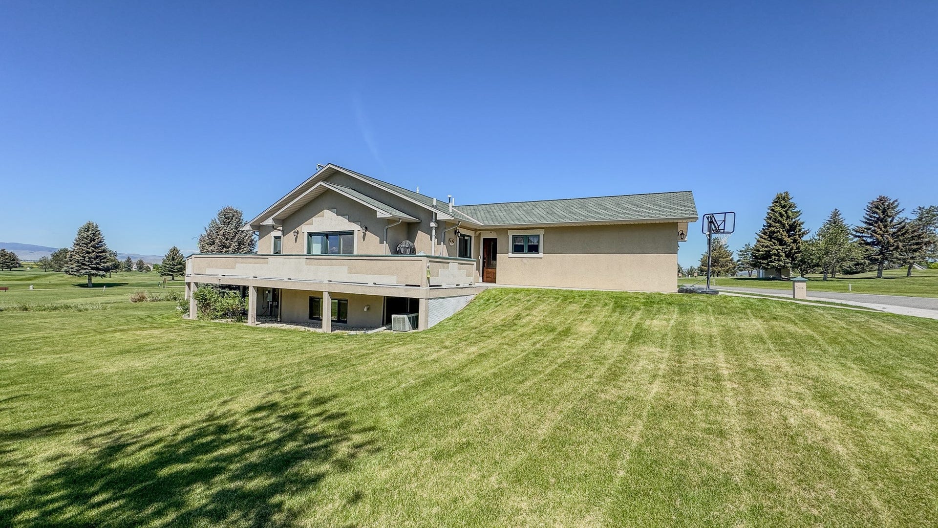 4134 Fox Ridge Drive, Helena, MT 59602 Back of house featuring a lawn and a wooden deck