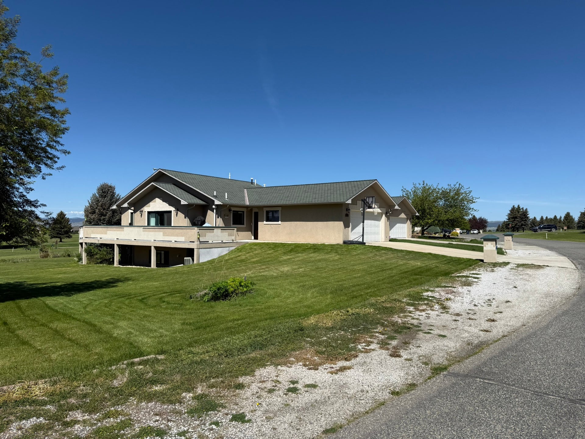 4134 Fox Ridge Drive, Helena, MT 59602 View of property exterior with concrete driveway, an attached garage, and a lawn