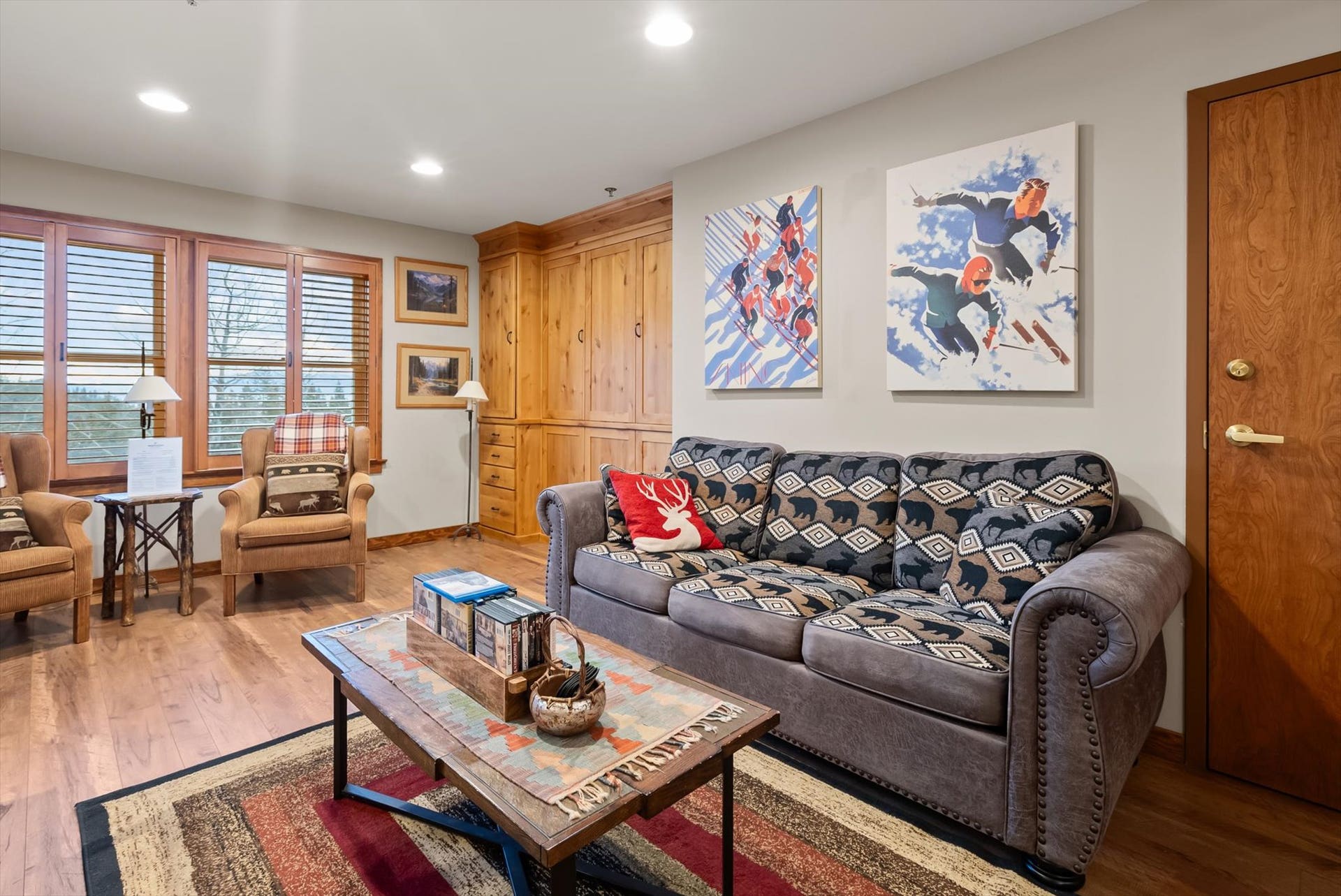 Living room featuring a custom cabinet with a murphy bed and storage