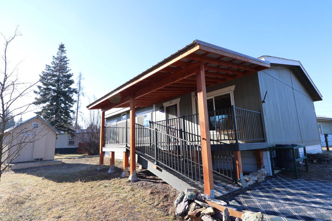 #30 Bear Creek Village, Bigfork, MT 59911 View of property exterior with a lawn and a storage shed