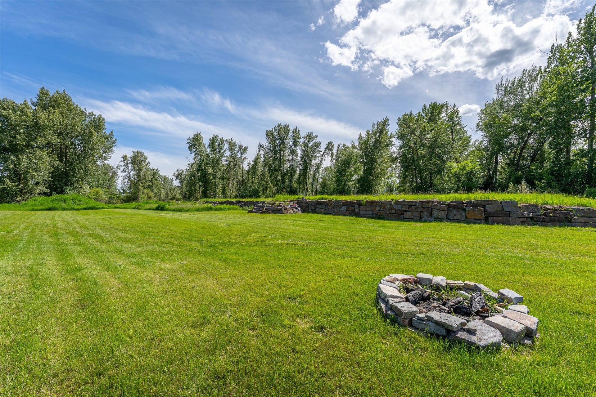 905 Wagner Lane, Kalispell, MT 59901 Fire pit with a view of the building pad in the background