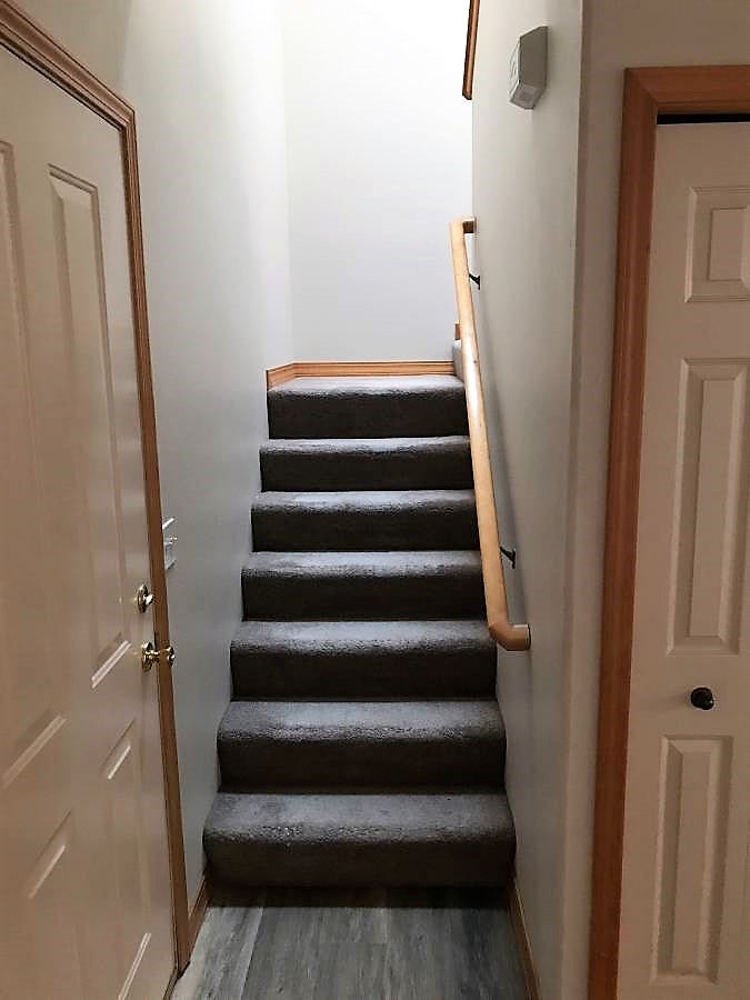 114 Sunrise Terrace, #114, Bigfork, MT 59911 Stairs featuring baseboards and wood finished floors