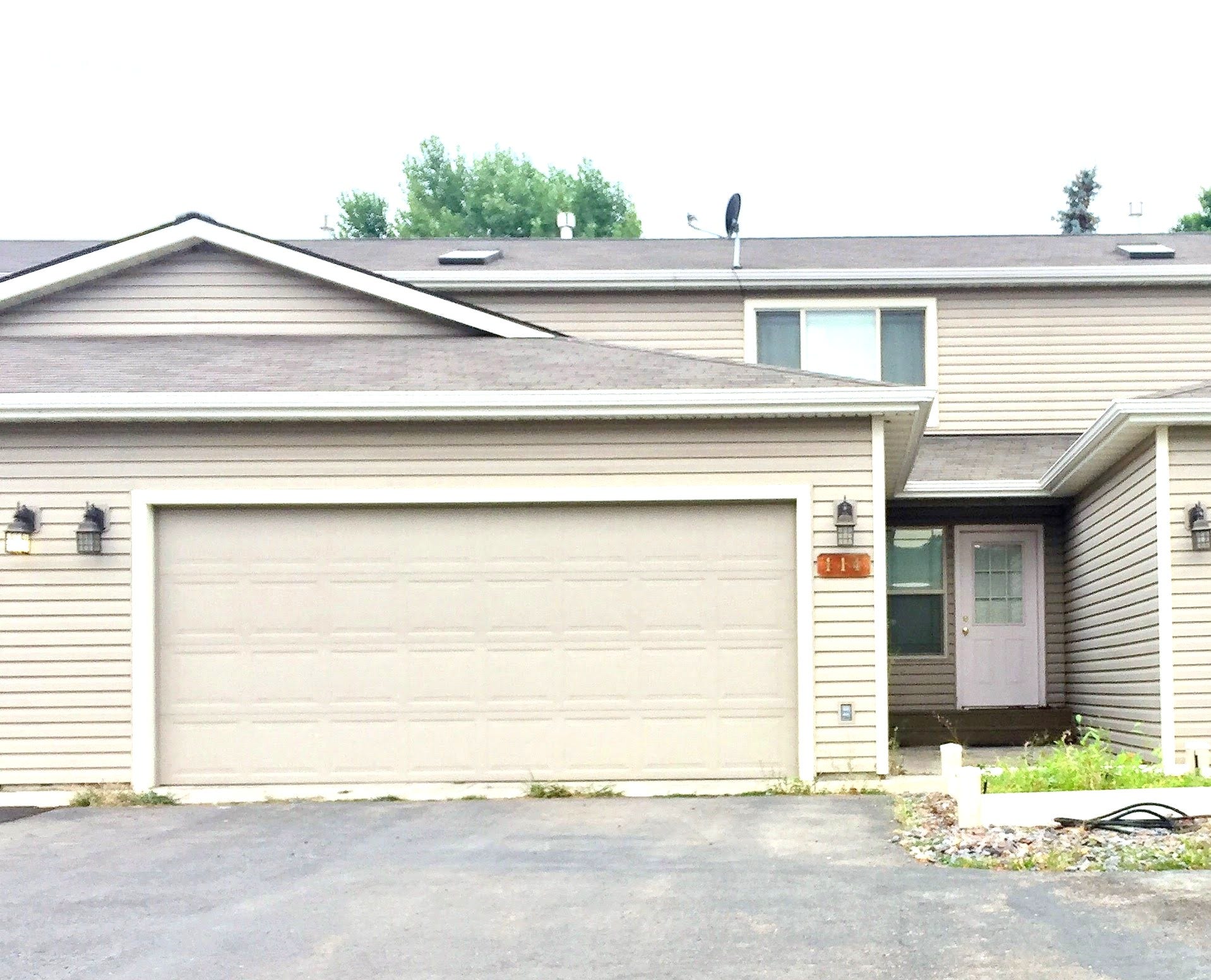 114 Sunrise Terrace, #114, Bigfork, MT 59911 View of property with an attached garage and aphalt driveway