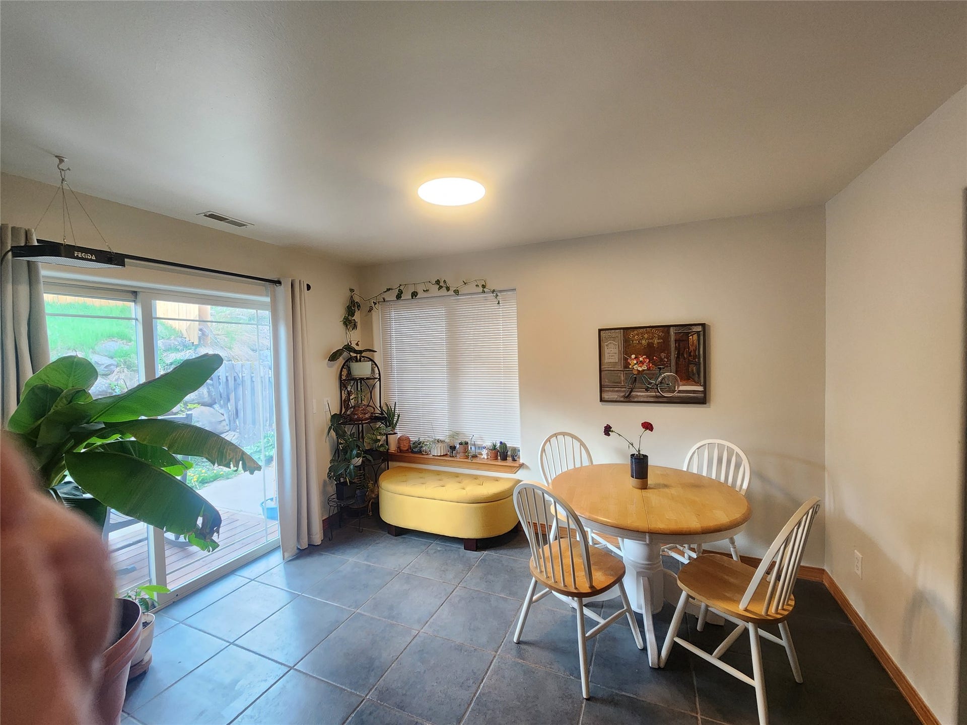 114 Sunrise Terrace, #114, Bigfork, MT 59911 Sliding glass door access to an outdoor deck, tile flooring, recessed ceiling lighting, and horizontal window blinds