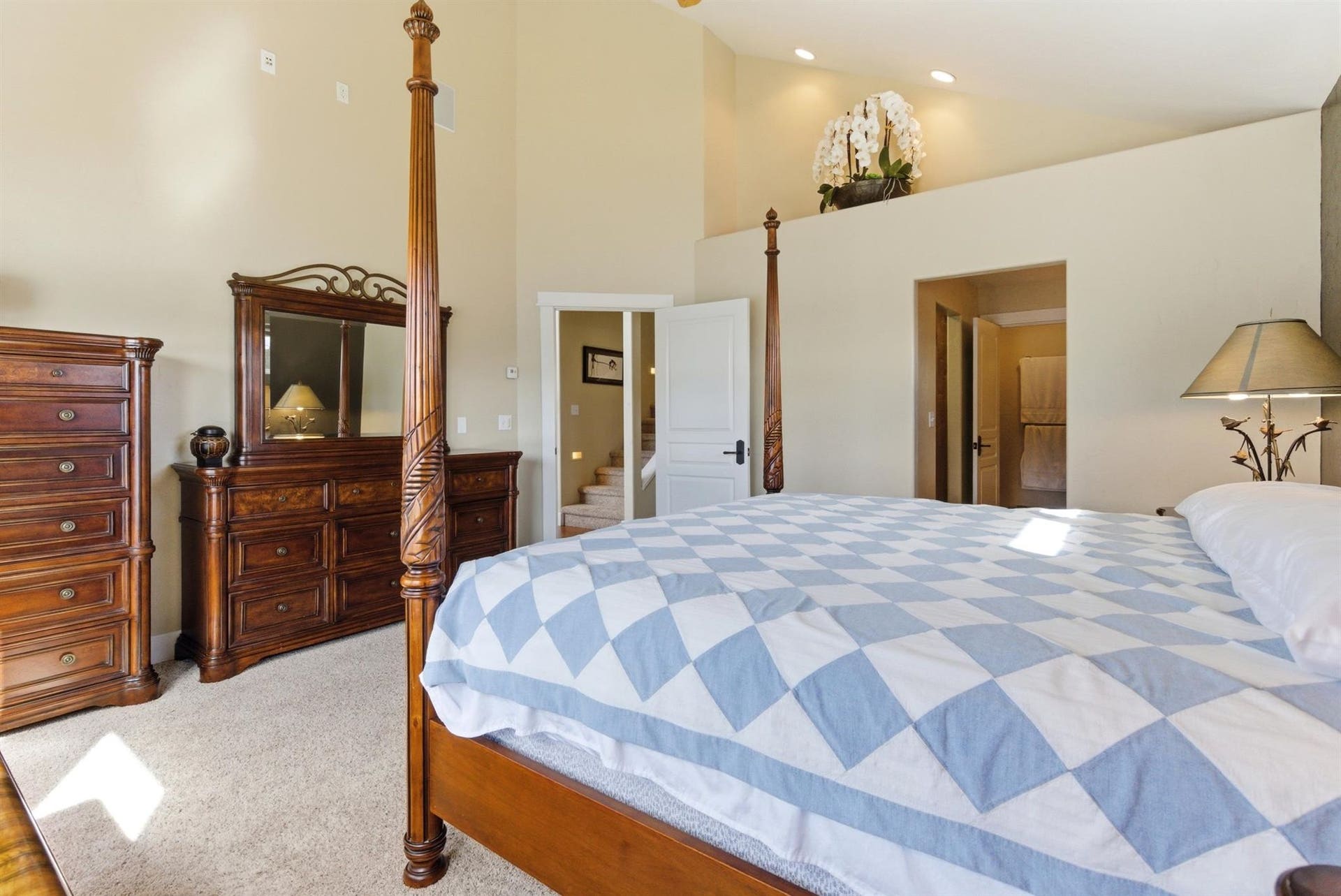45 Roybals Way, Kalispell, MT 59901 Bedroom with light colored carpet, vaulted ceiling, ensuite bathroom, and recessed lighting