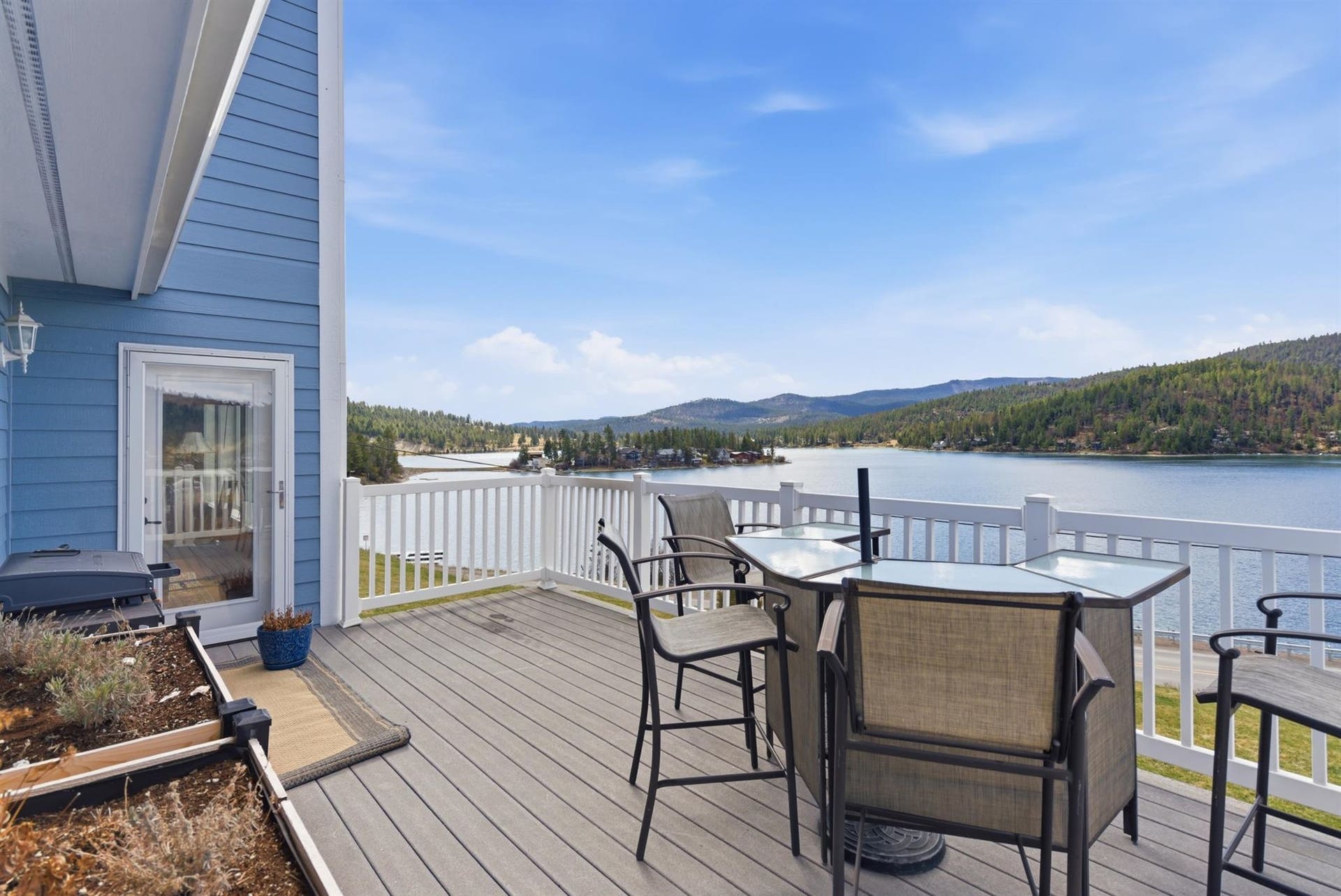 45 Roybals Way, Kalispell, MT 59901 Wooden deck featuring a water and mountain view and outdoor dining area