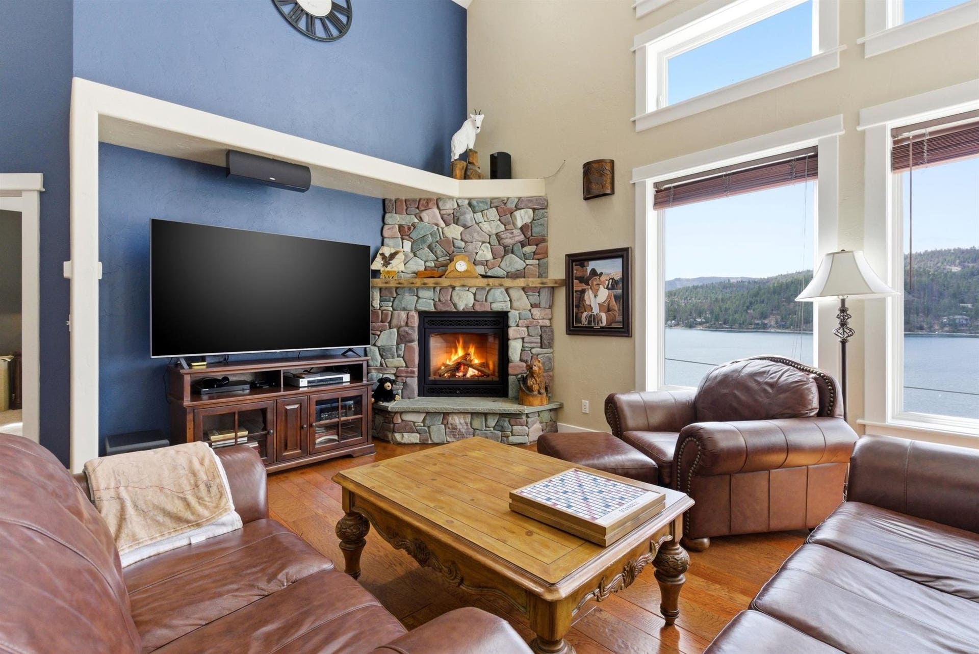 45 Roybals Way, Kalispell, MT 59901 Living area featuring a fireplace, hardwood / wood-style flooring, a high ceiling, and a water view