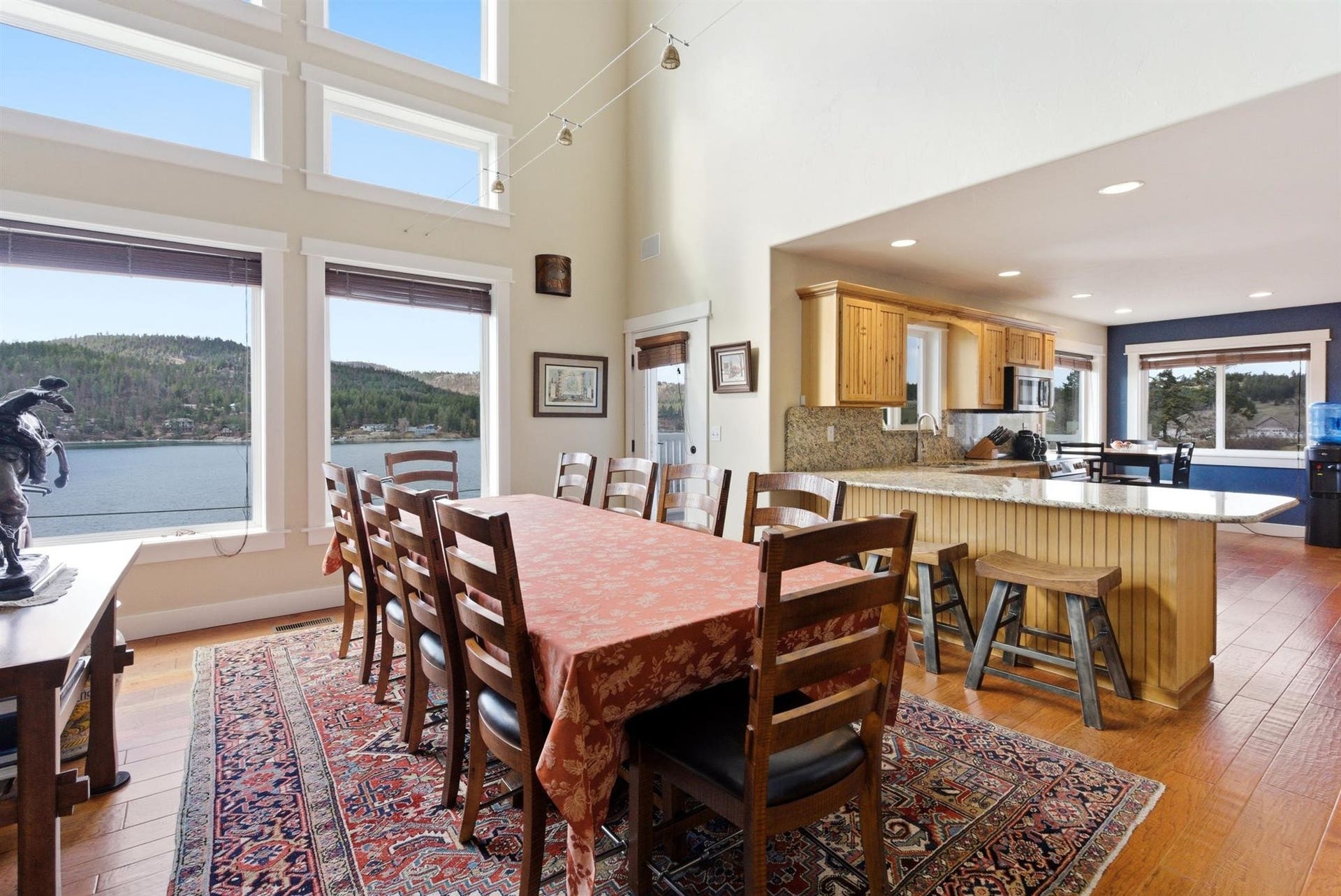 45 Roybals Way, Kalispell, MT 59901 Dining space featuring light wood-type flooring, a high ceiling, recessed lighting, and a water and mountain view