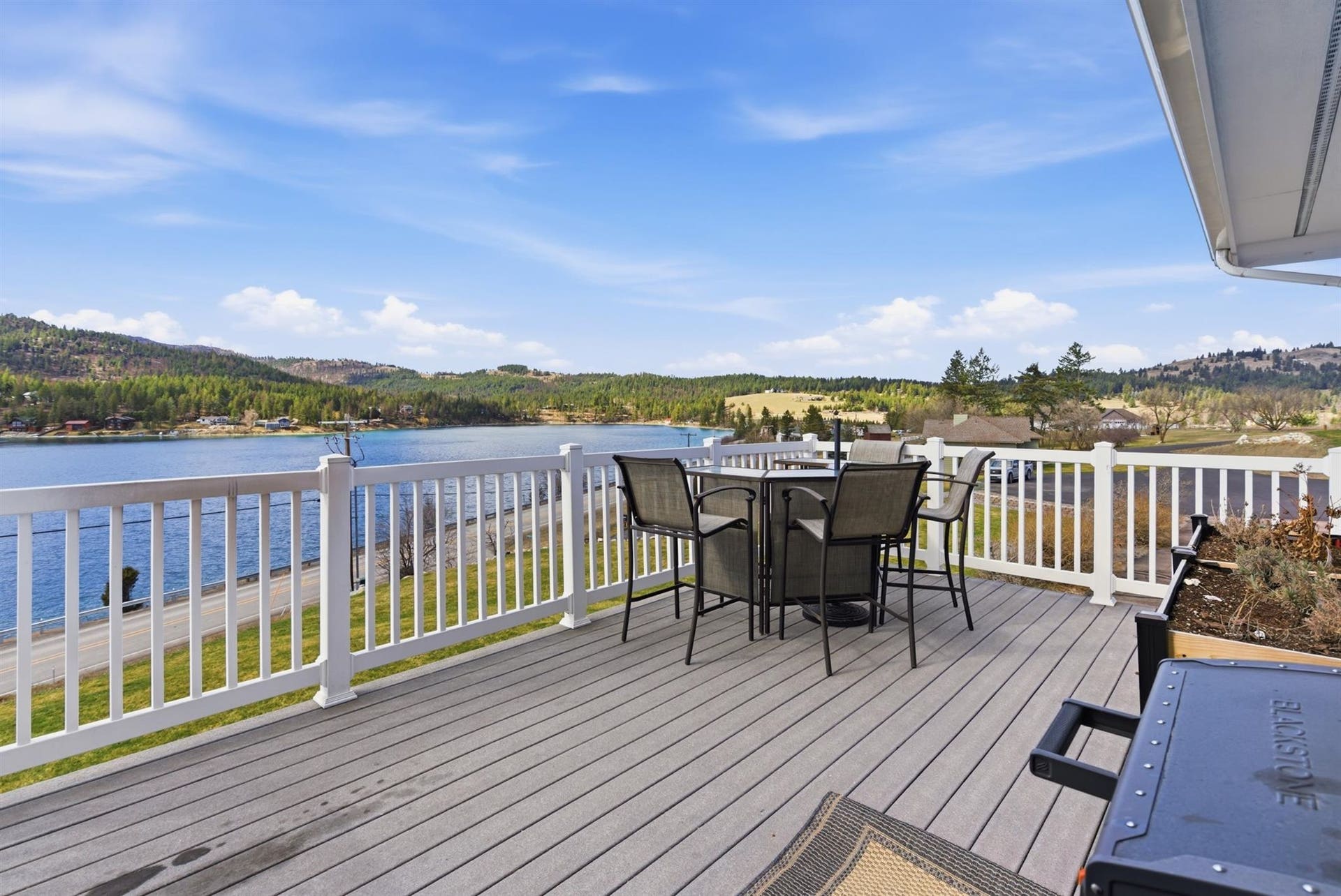 45 Roybals Way, Kalispell, MT 59901 Wooden deck with outdoor dining area and a water and mountain view