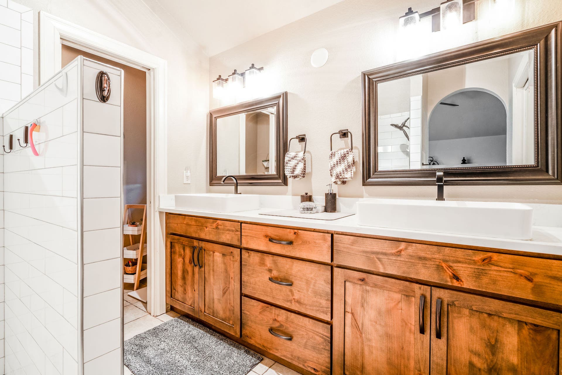 163 Crestview Drive, Bigfork, MT 59911 Updated primary bath with a double vanity, vessel sinks, and rustic wood cabinetry