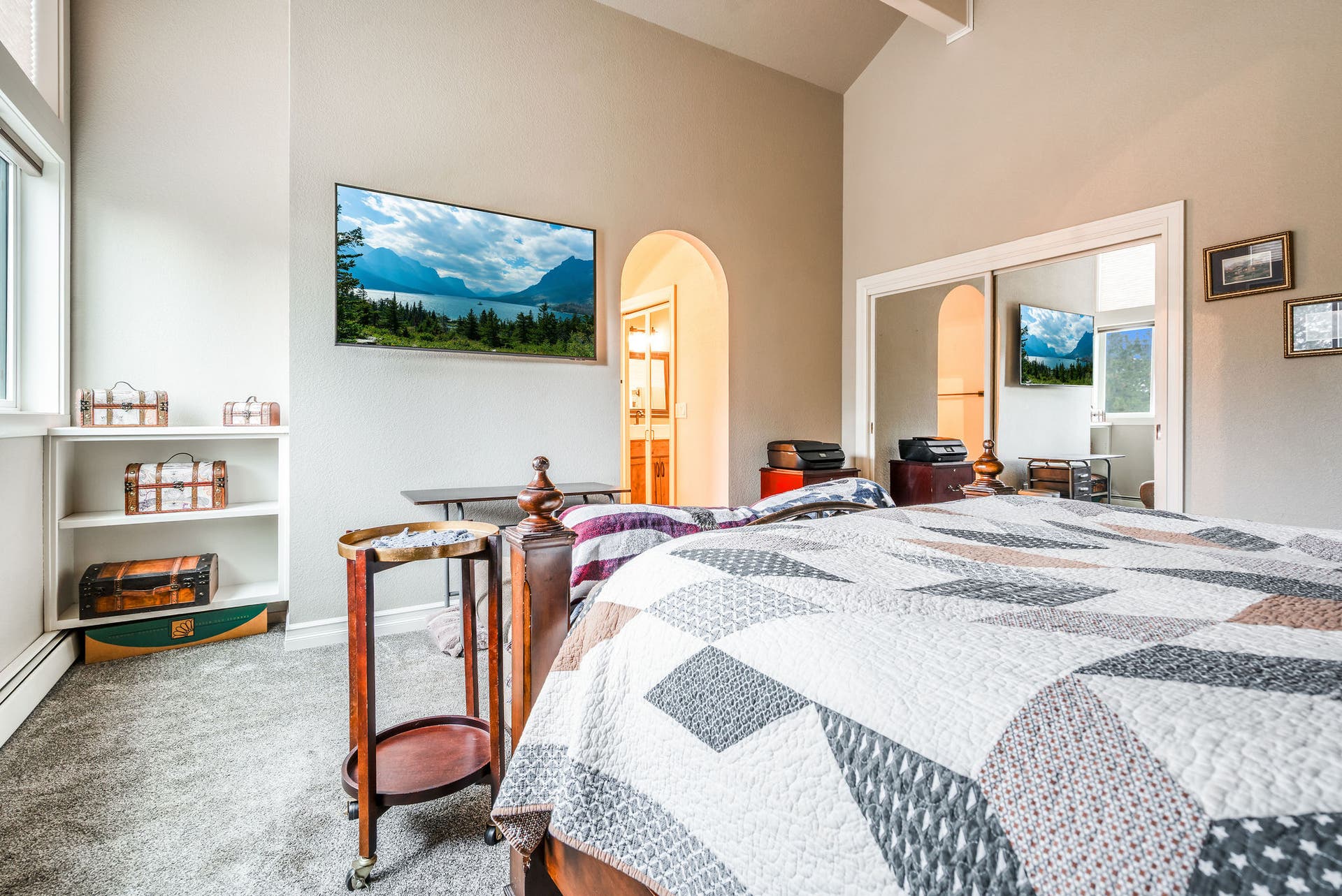 163 Crestview Drive, Bigfork, MT 59911 Spacious primary suite with a modern arched doorway leading to the bathroom
