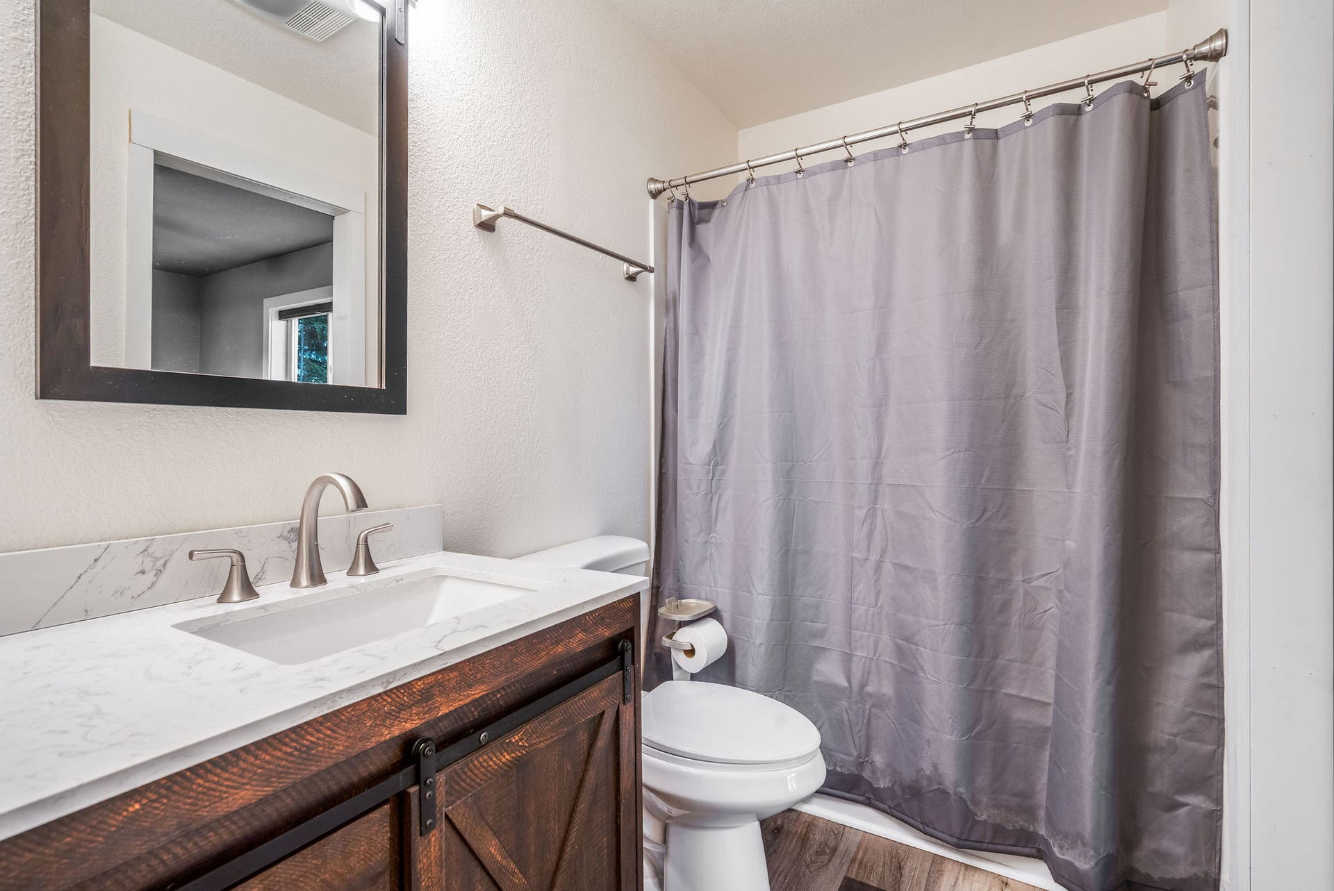 163 Crestview Drive, Bigfork, MT 59911 Ensuite bathroom with neutral finishes, a large mirror, and a clean tub/shower combination