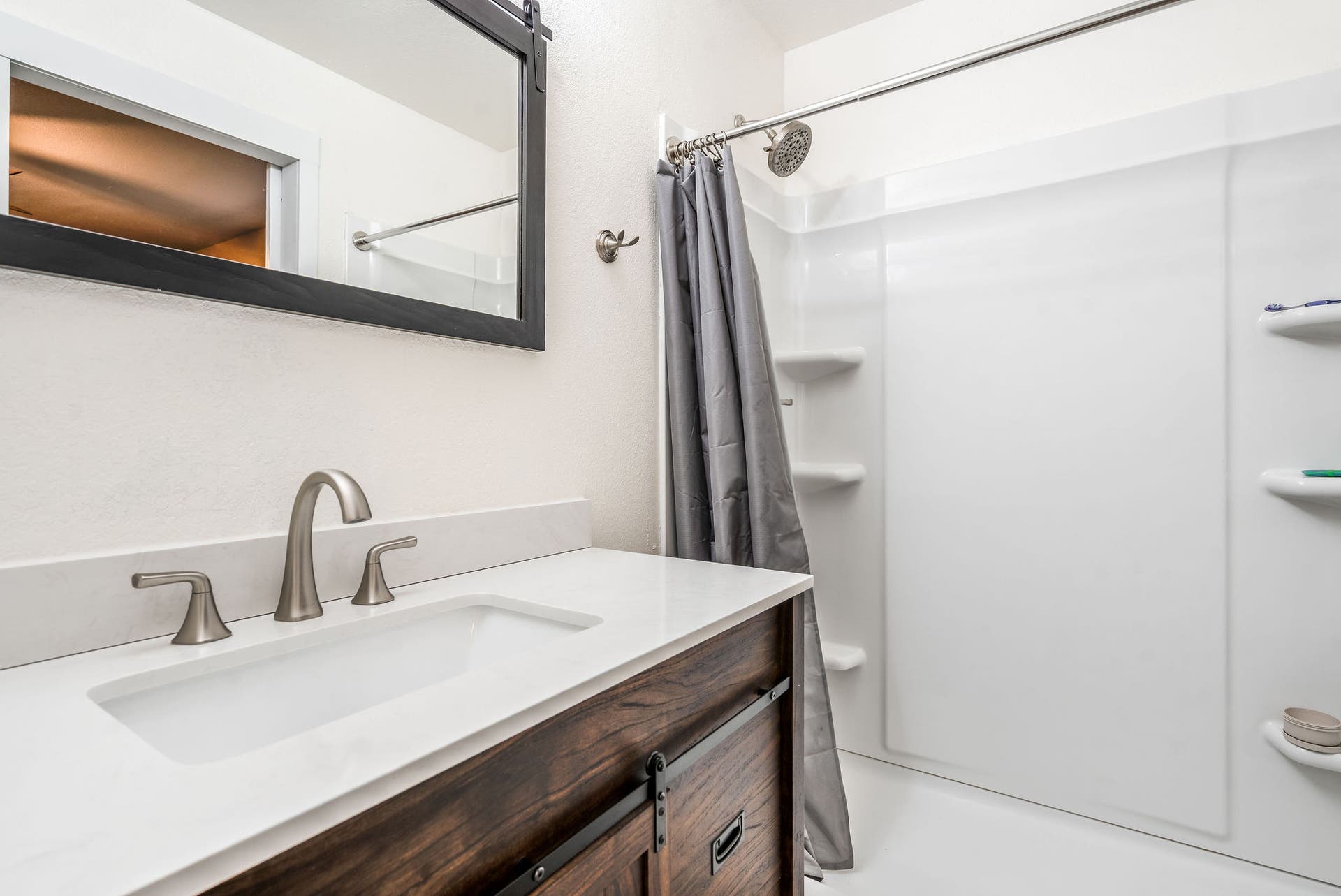 163 Crestview Drive, Bigfork, MT 59911 Bright ensuite bath showcasing a clean white shower surround and sleek quartz-style countertops
