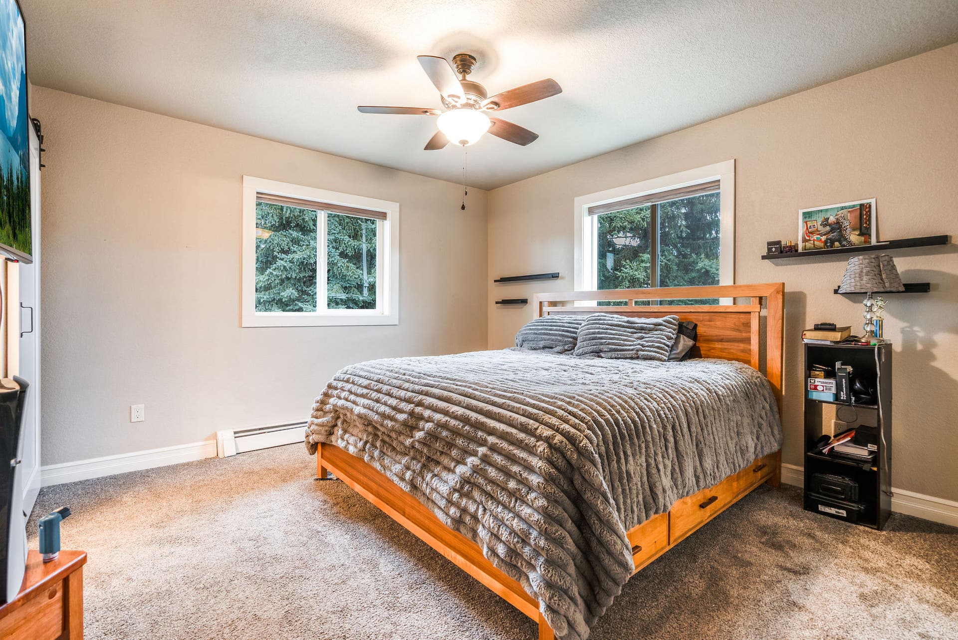 163 Crestview Drive, Bigfork, MT 59911 Spacious fifth bedroom with a ceiling fan and large windows