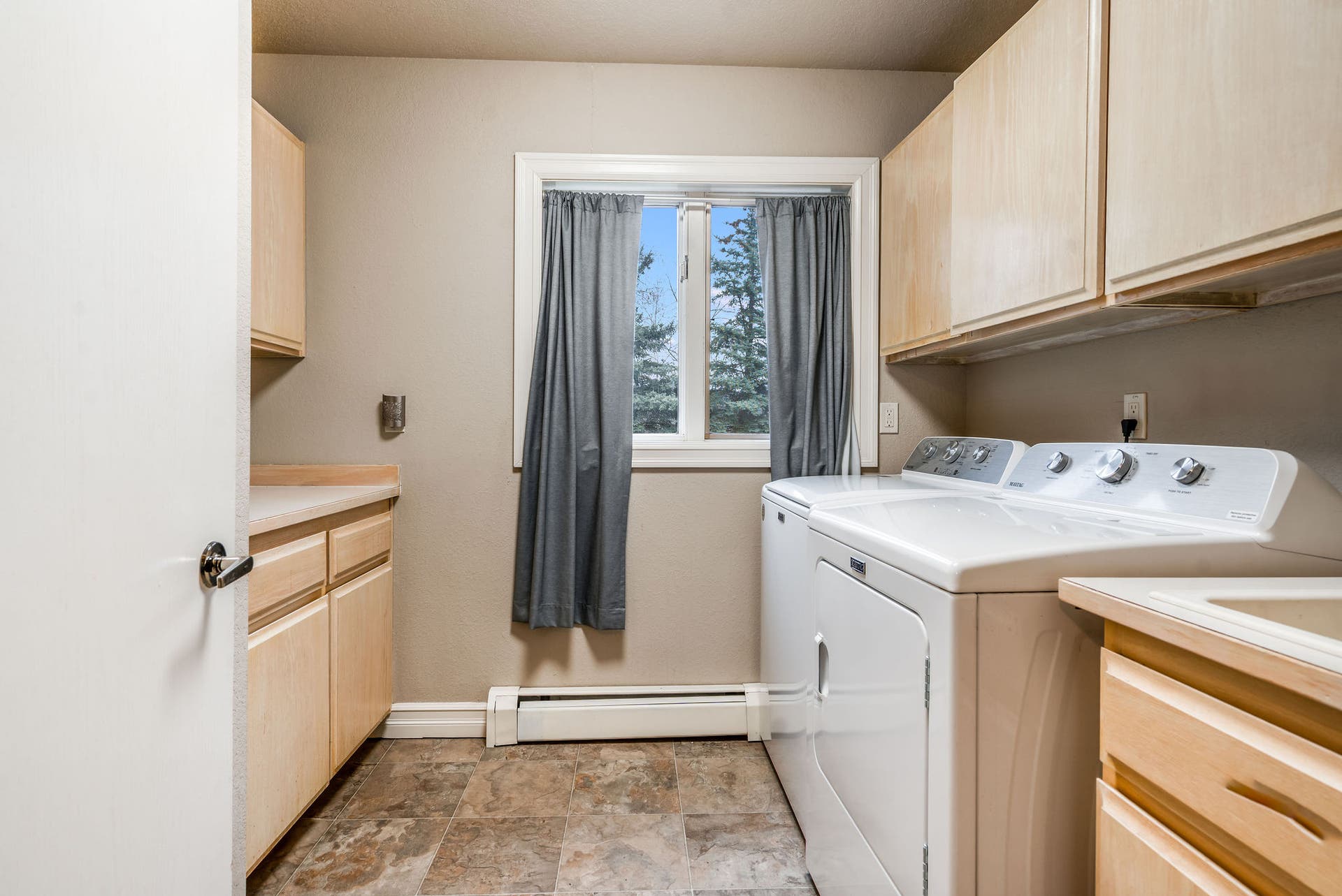 163 Crestview Drive, Bigfork, MT 59911 Laundry room with upper cabinetry and plenty of workspace