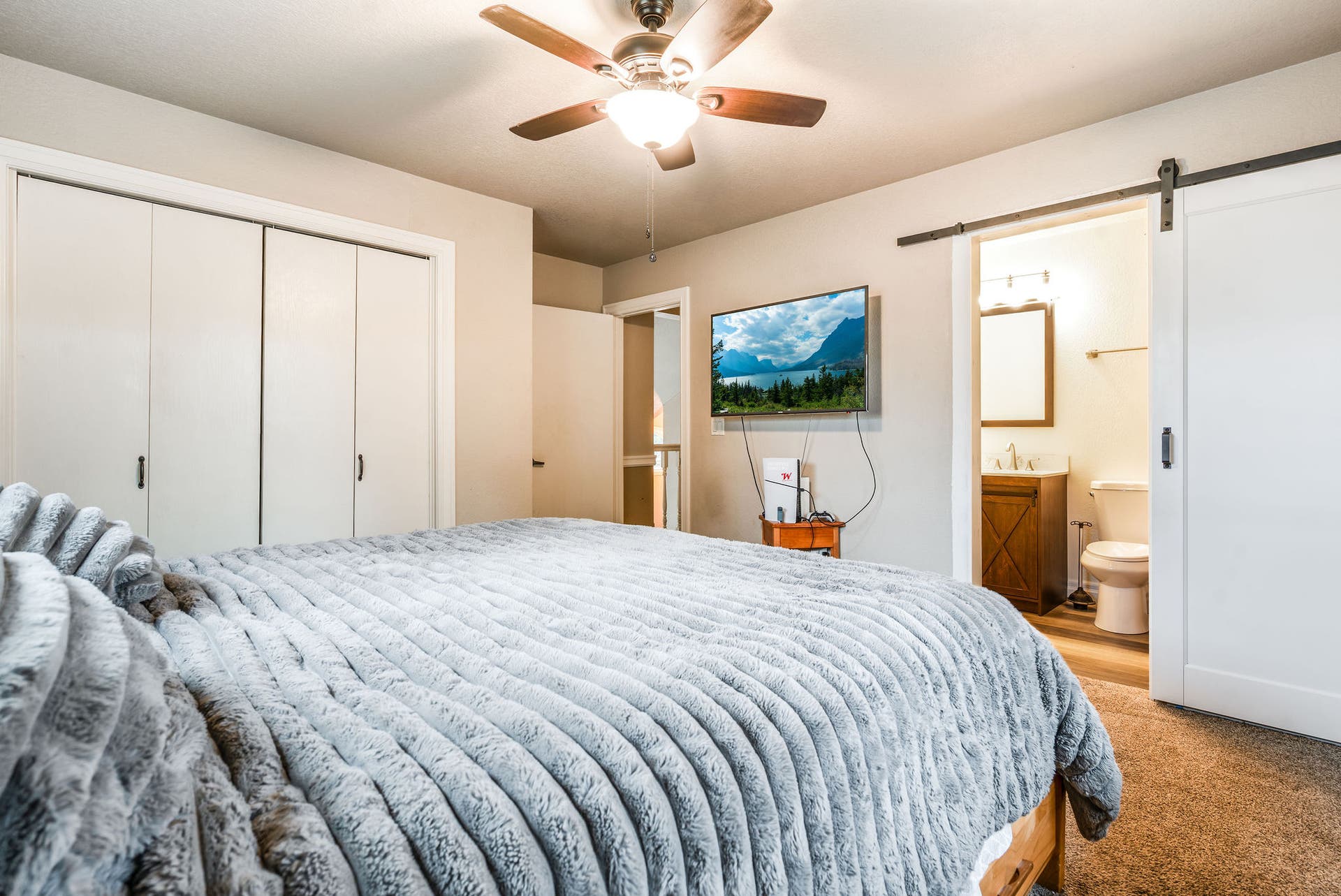 163 Crestview Drive, Bigfork, MT 59911 Fifth bedroom featuring a large closet and convenient access to the adjacent updated ensuite bathroom