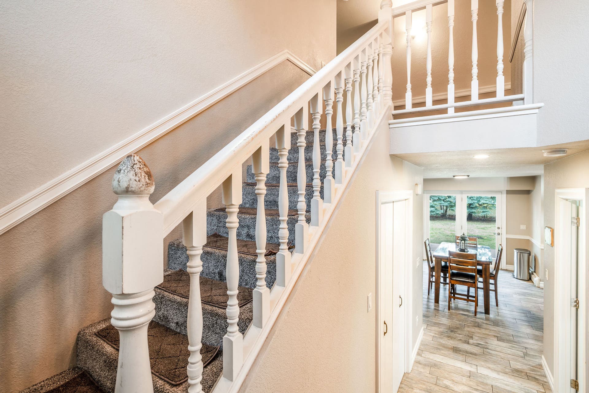 163 Crestview Drive, Bigfork, MT 59911 Classic staircase with white spindles leading from the main level to the upper-floor bedrooms