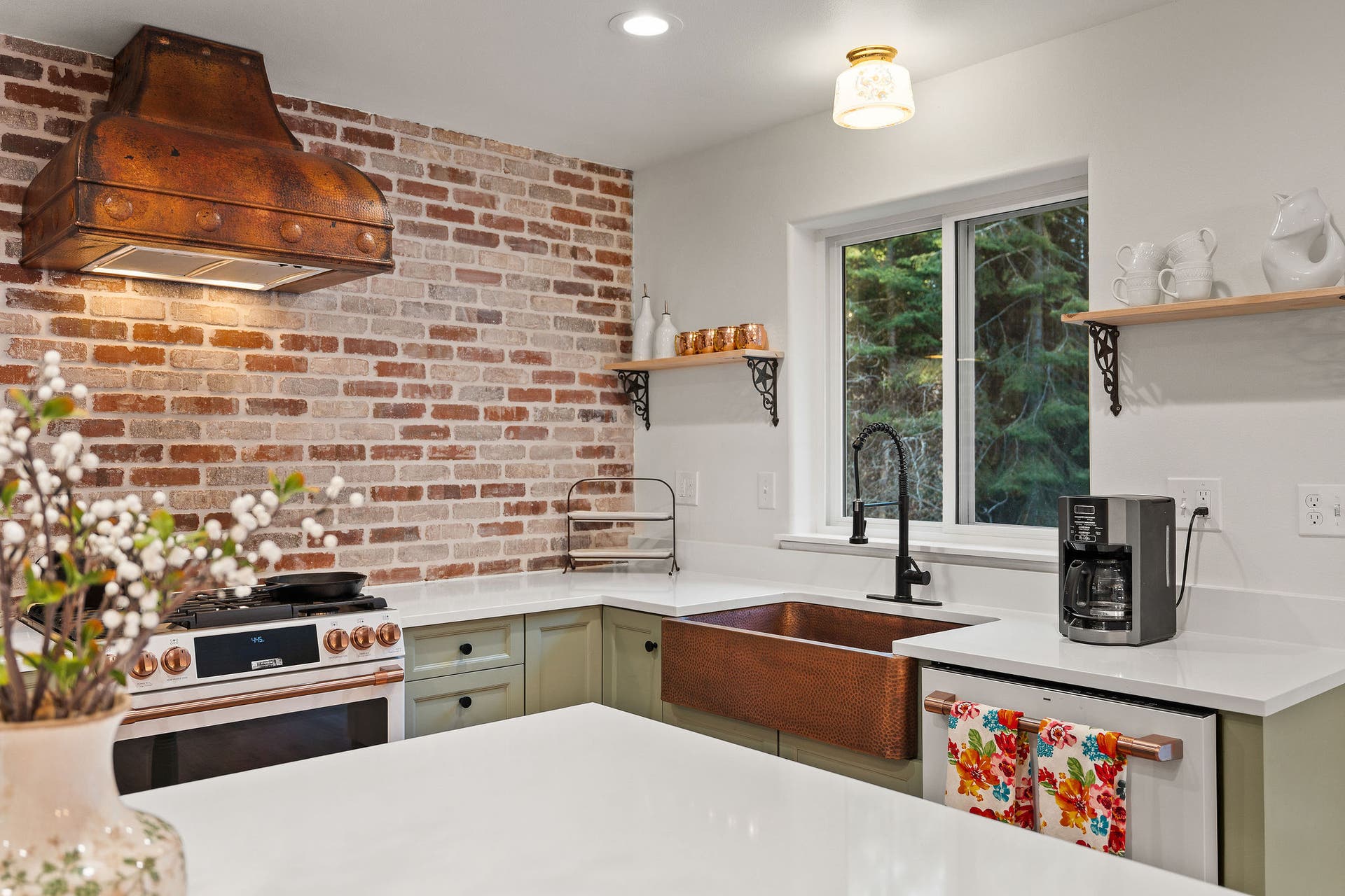 620 Swan River Road, Bigfork, MT 59911 Striking brick backsplash with stunning copper range hood and sink