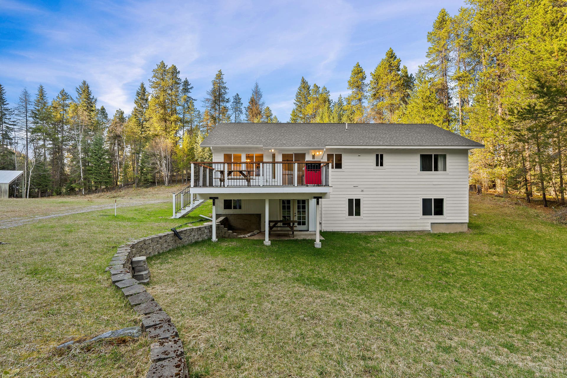 620 Swan River Road, Bigfork, MT 59911 Back of house with large deck