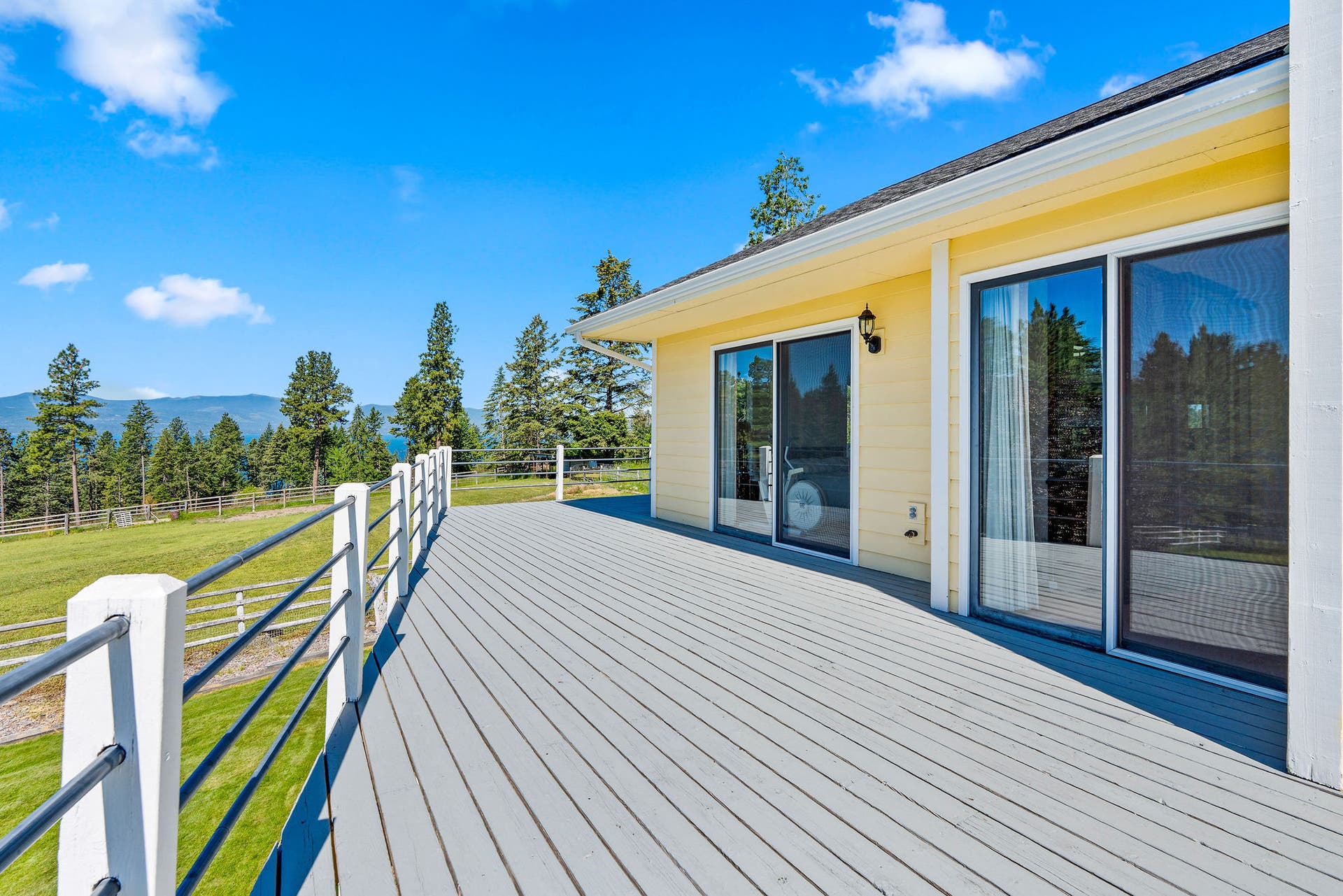 33676 Hilltop Terrace, Bigfork, MT 59911 Wood deck w/ metal pipe railing