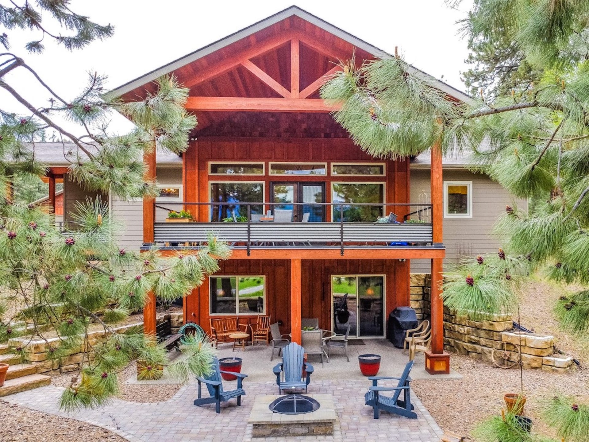 110 Conifer Lane, Bigfork, MT 59911 Rear view of property with a fire pit, a balcony, and a patio area
