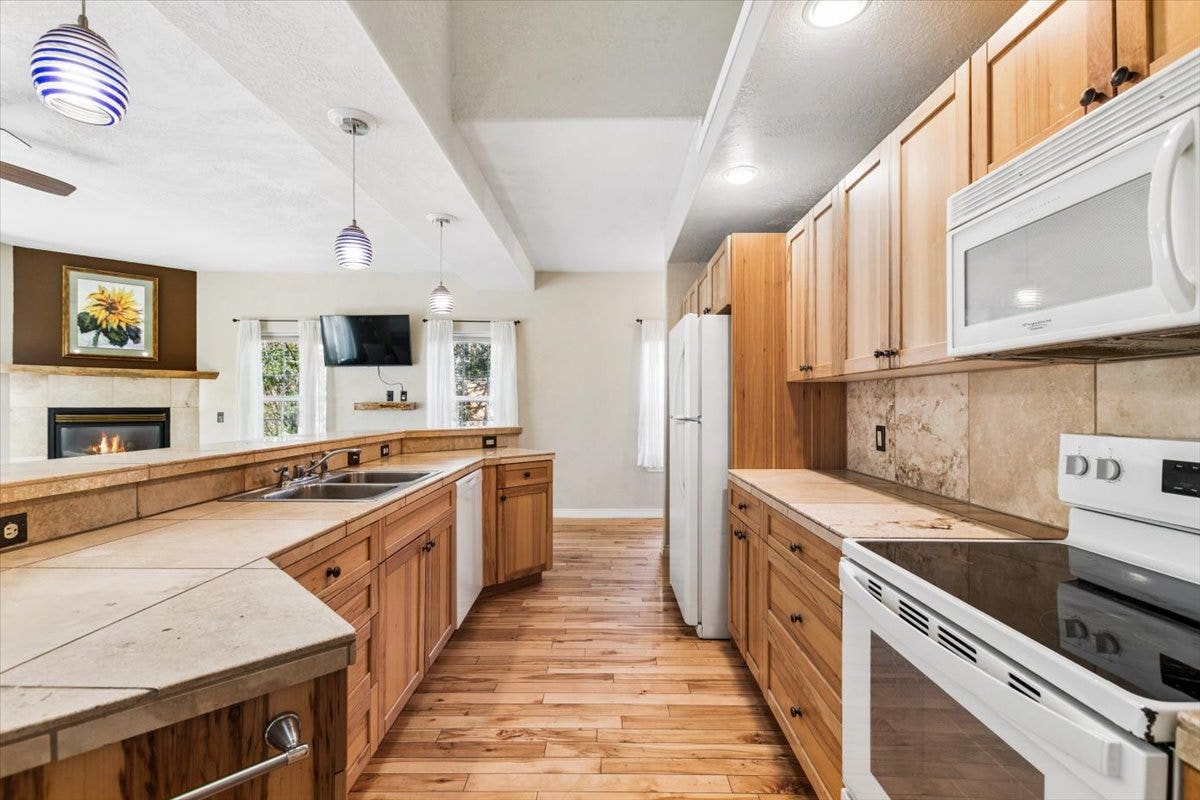 108 Sunrise Terrace, #D, Bigfork, MT 59911 Kitchen with hardwood flooring and travertine tile