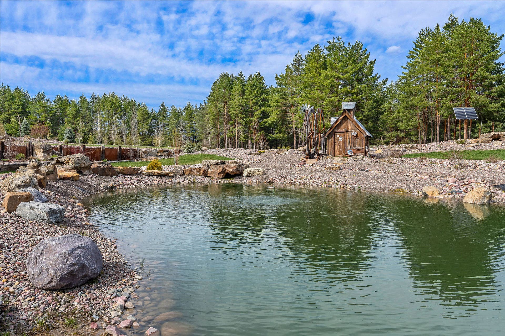 310 Rocky Woods Lane, Bigfork, MT 59911 Integrated natural boulders and layered structural materials for longevity and beauty