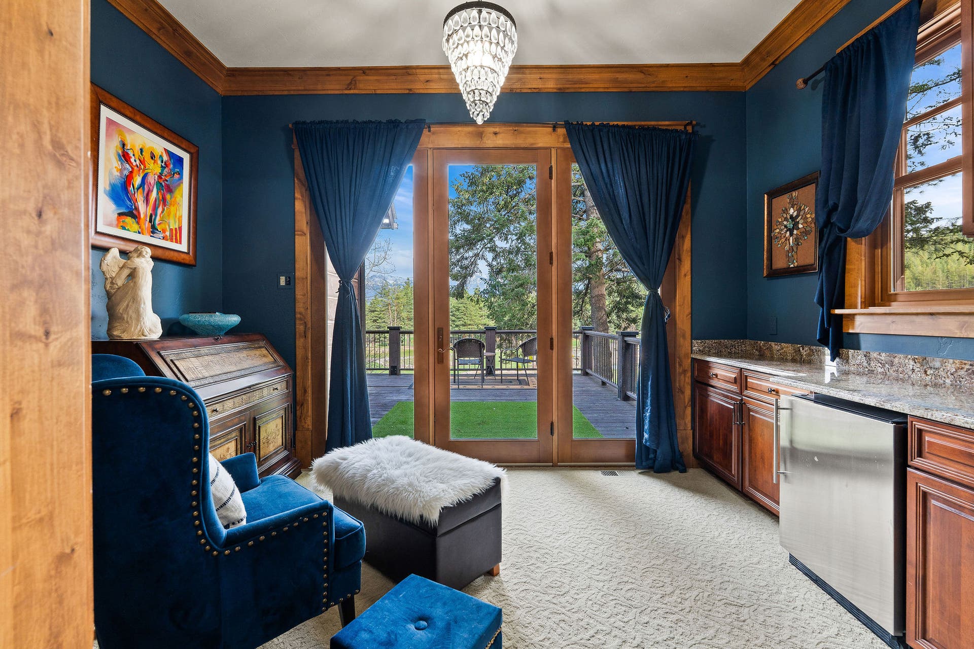 310 Rocky Woods Lane, Bigfork, MT 59911 Primary suite sitting area with wet bar, cherry cabinets, access to library, & access to deck
