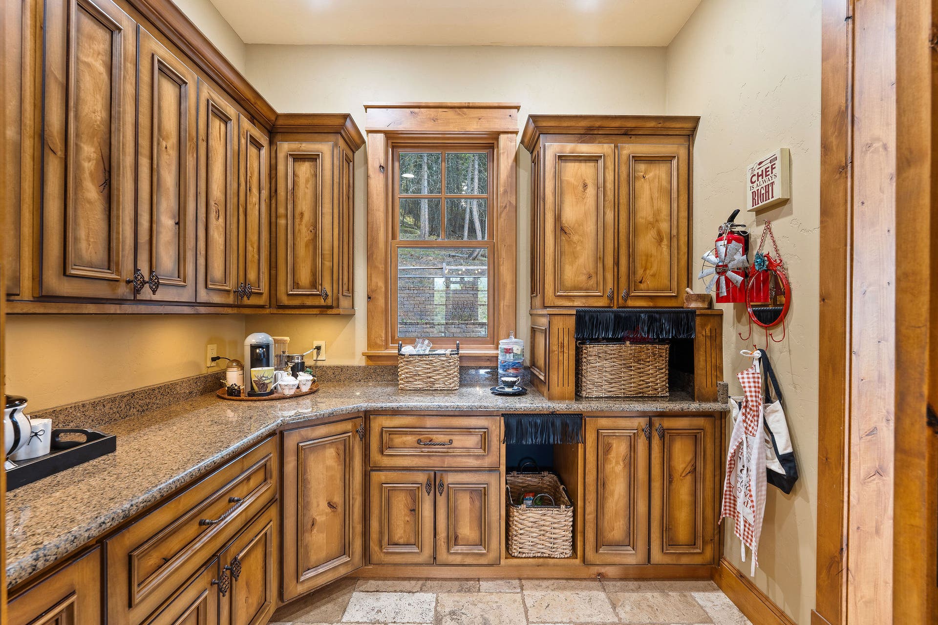 310 Rocky Woods Lane, Bigfork, MT 59911 Butler's pantry with knotty alder cabinets, and warming drawer