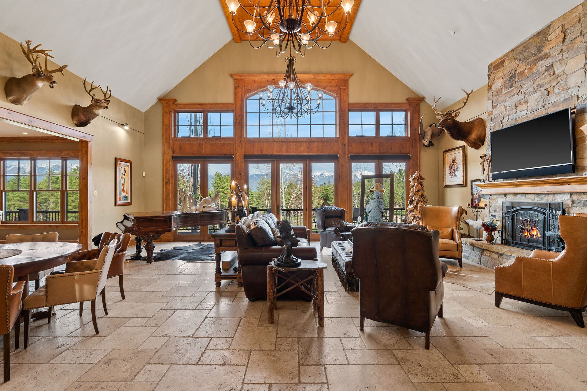 310 Rocky Woods Lane, Bigfork, MT 59911 Vaulted ceiling & large picture windows frame Swan Mountain Range view